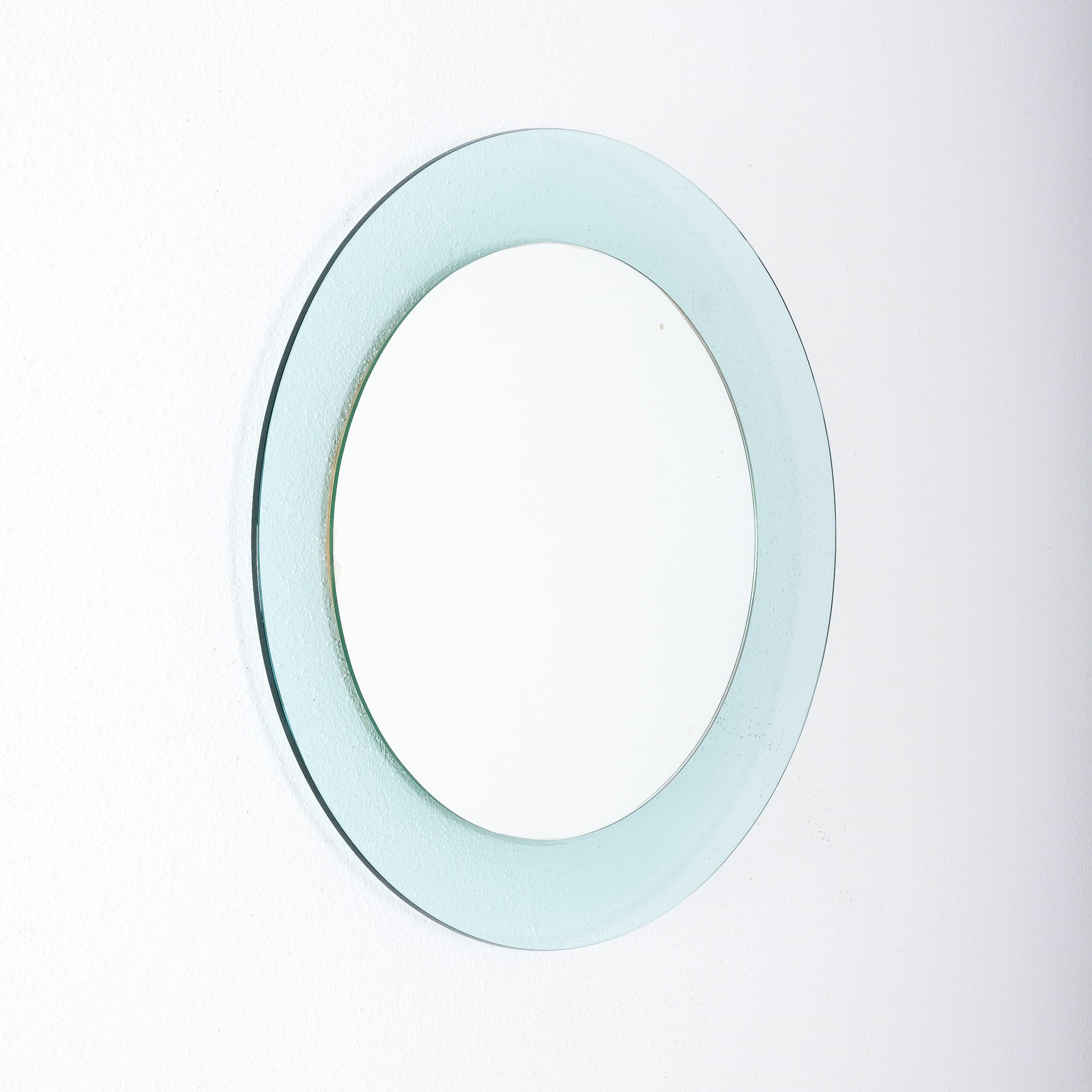 Mod. 1699 mirror by Max Ingrand, Fontana Arte, Italy.

Max Ingrand round blue mirror Fontana Arte Model 1699, Italy, circa 1968. Elegant light blue-turquoise curved and beveled glass framing mirrored glass. Good condition with no chips. One small