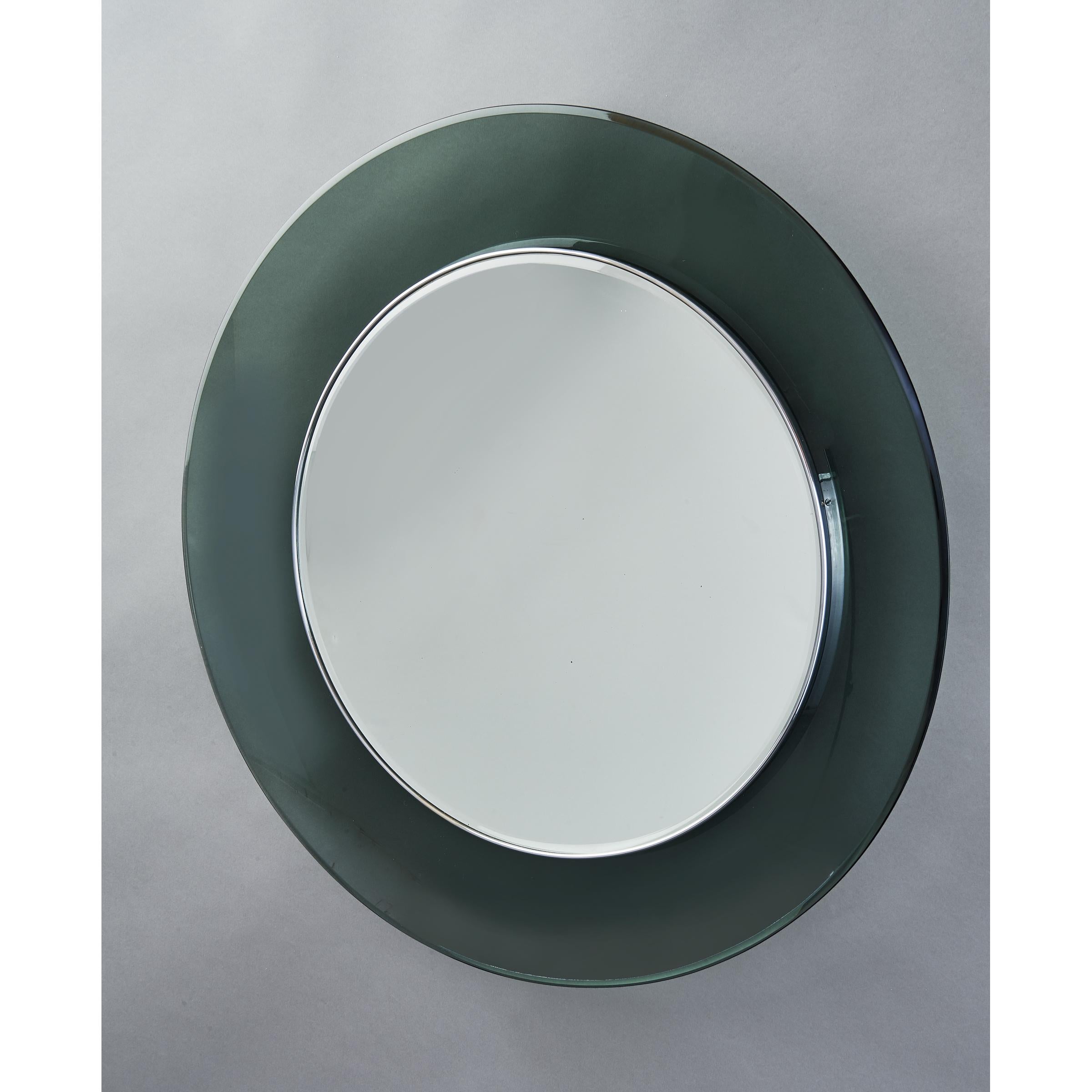 Max Ingrand (1908-1969) for Fontana Arte
Round colored glass mirror in the Classic grey green tone, curved glass bowl with beveled edge and inner nickeled brass frame
Italy, 1960s
Measures: Diameter 28 