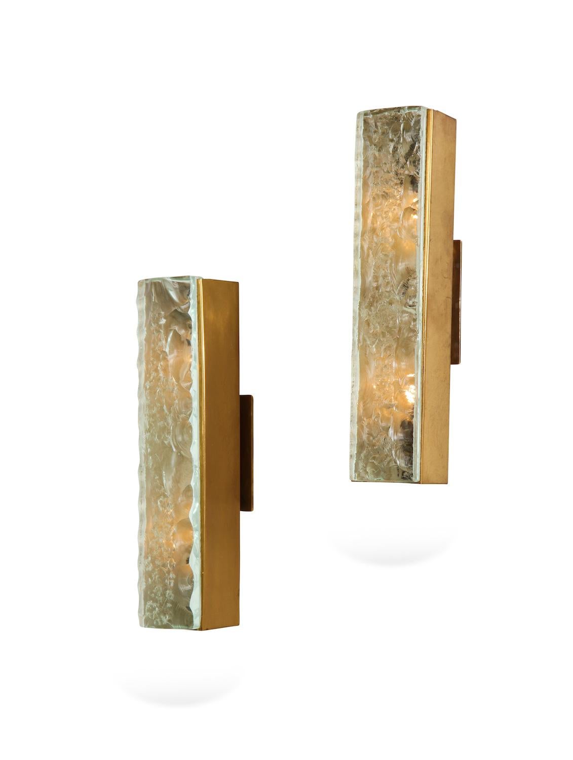 Pair of #2368 sconces by Max Ingrand for Fontana Arte. Rare forms of rectangular brass structures with thick, chipped-glass faces. Each sconce has 2 candelabra sockets inside. Published: Fontana Arte, Bagno, 1965. Manufacturers self-published