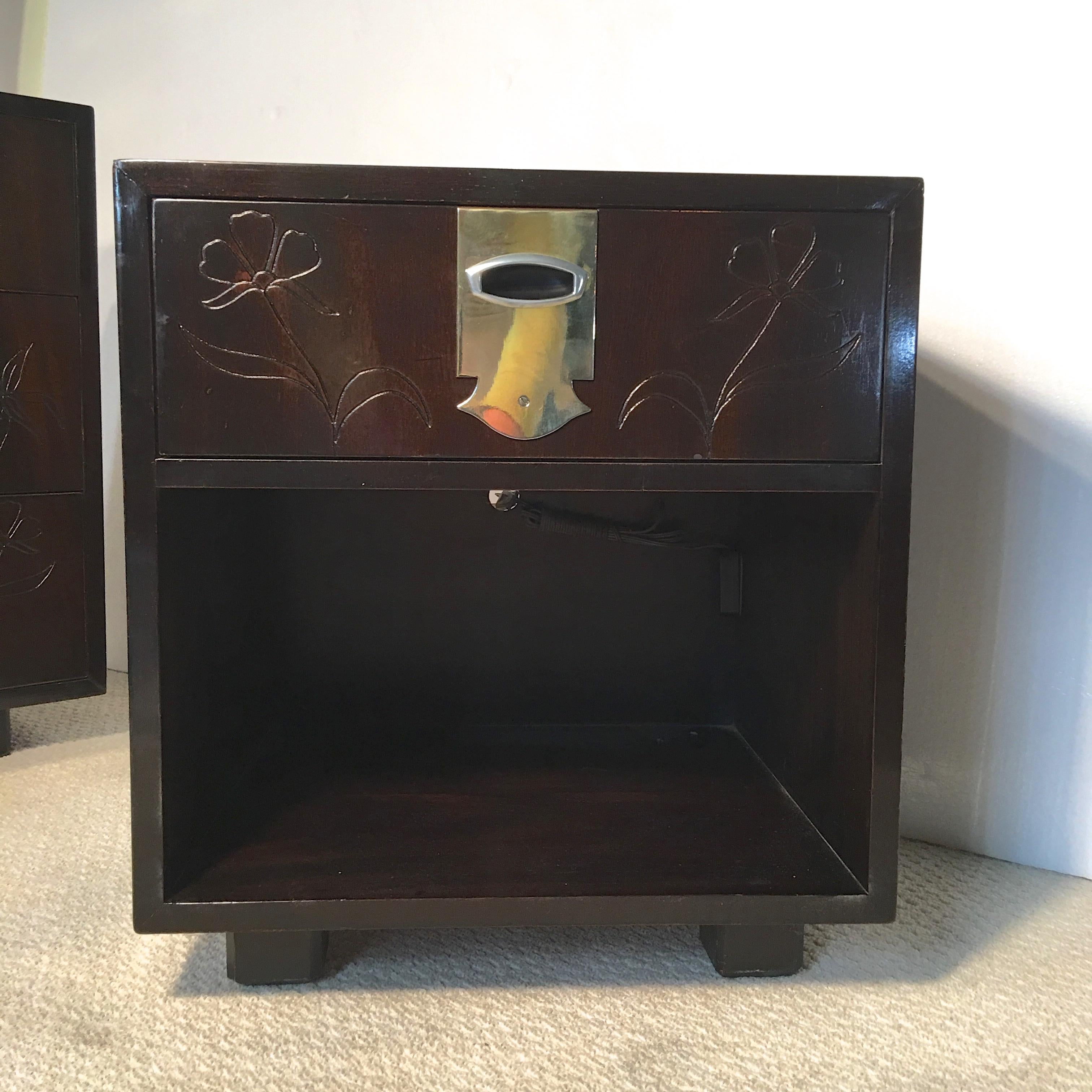 Single nightstand with an open cabinet and single drawer above, the face of which has been decoratively incised with a pattern of flowers and embellished with solid brass belting, circa 1959. 
Very clean inside and out. Patination to brass.