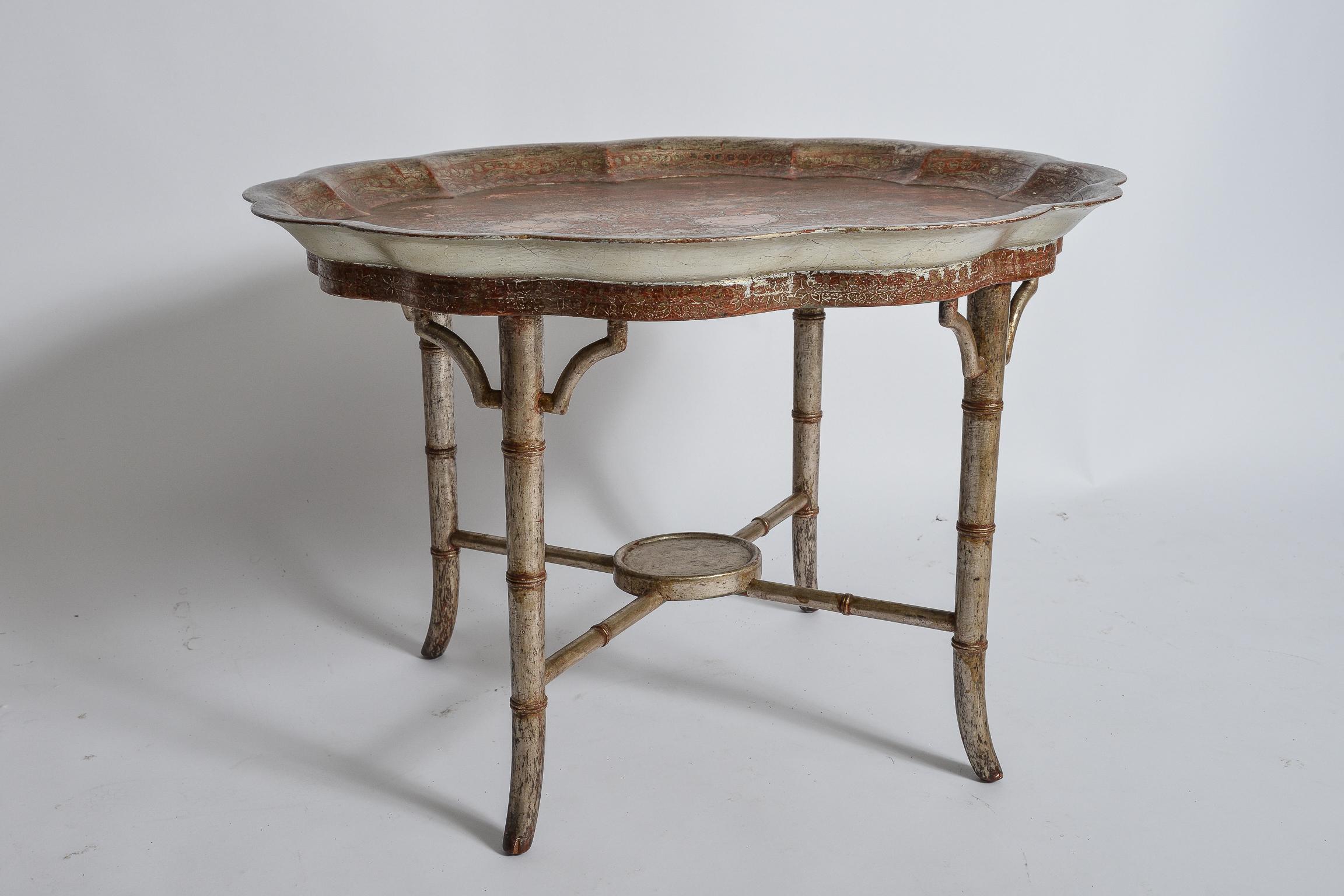 Max Kuehne Silver Leaf and Gessoed Table.
Hand Carved floral and geometric Decoration
Bamboo carved leg structure surmounted by a piecrust tray top.
Carved signature of artist
