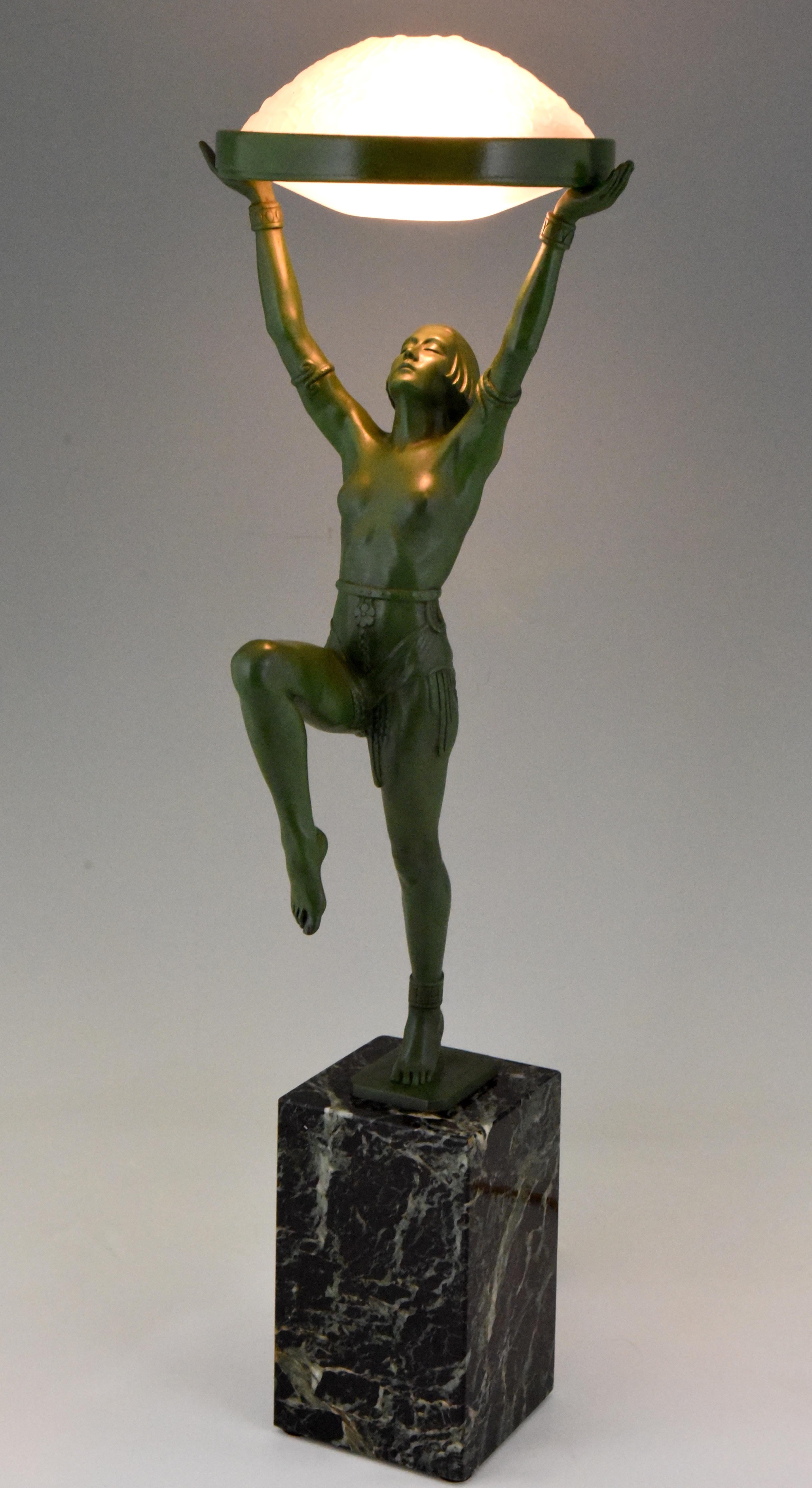 Art Deco bronze figural table lamp of a dancer holding a glass shade 
