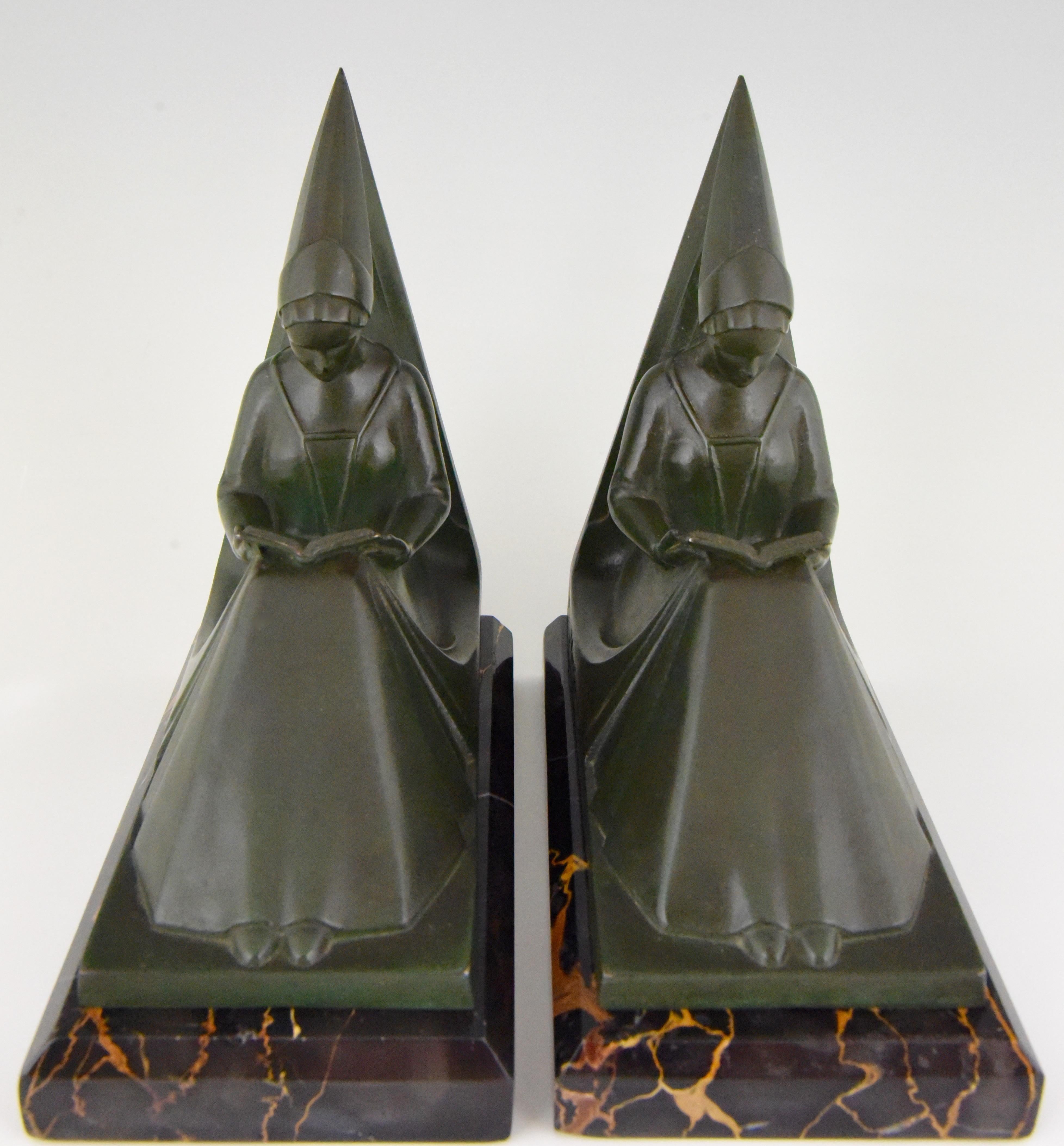 Lovely pair of Art Deco bookends modelled as reading ladies wearing medieval clothes and hat. The patinated Art Meatl sculptures are mounted on Portor marble bases and signed by the artist Max Le Verrier, France, 1925-1930.
Size of one:
H. 15.5