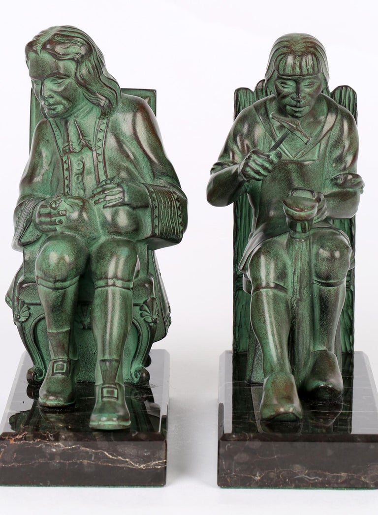 A superb pair French Art Deco green patinated bronze figural bookends by renowned sculptor Max Le Verrier (1891-1973) dating from 1930/40's. The bookends portray a seated gentleman holding bags on money on his lap while the other shows a shoe maker