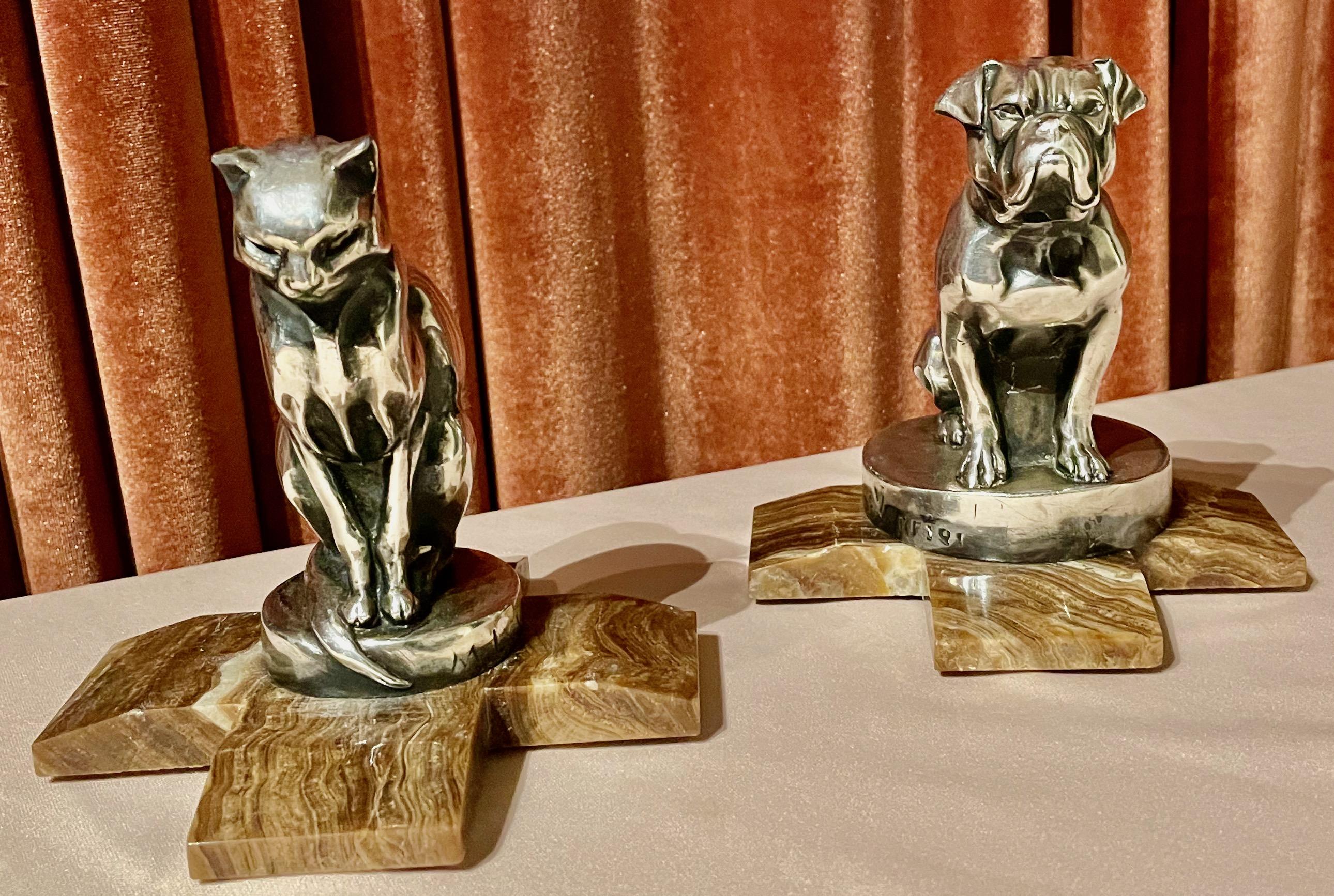 A pair of Art Deco figural bookends in the shape of a cat and bulldog by the French artist Max Le Verrier. These are silvered finish and arrived without the marble base. We were able to make this custom base fitting which helps to give these two