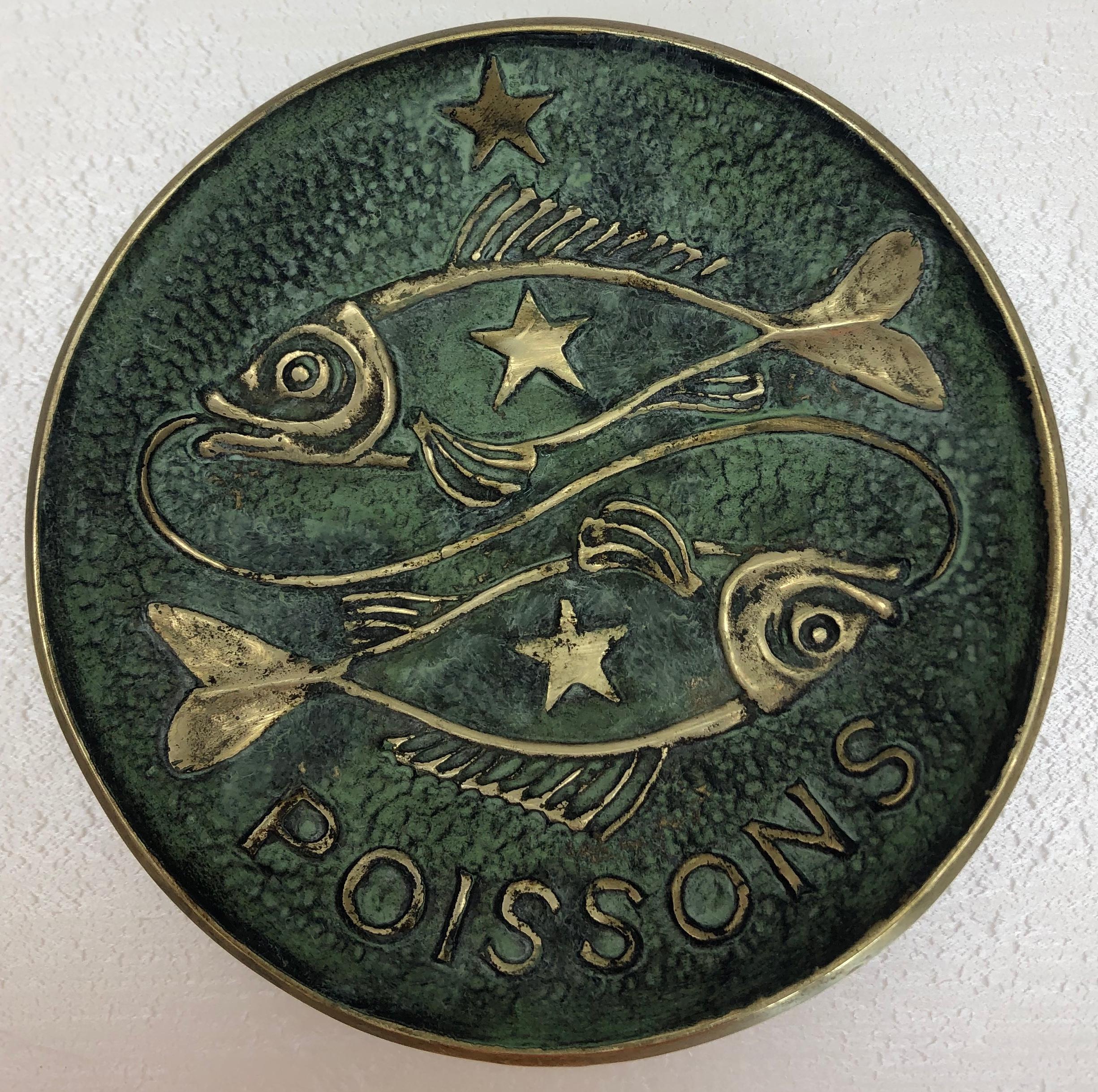 Bronze by Max Le Verrier that makes a great key holder/vide-poche.

The fish symbols are absolutely beautiful, they represent the zodiac sign of those born 21 February - 20 March as is indicated on the bottom of this charming decorative object.