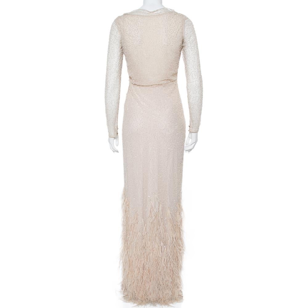 To help you sway in the most mesmerizing way, Max Mara brings you this evening gown that is too beautiful for words. It is a marvelous design, achieved by using sequin embellishments, feather detailing, and tulle into a dreamy silhouette. The