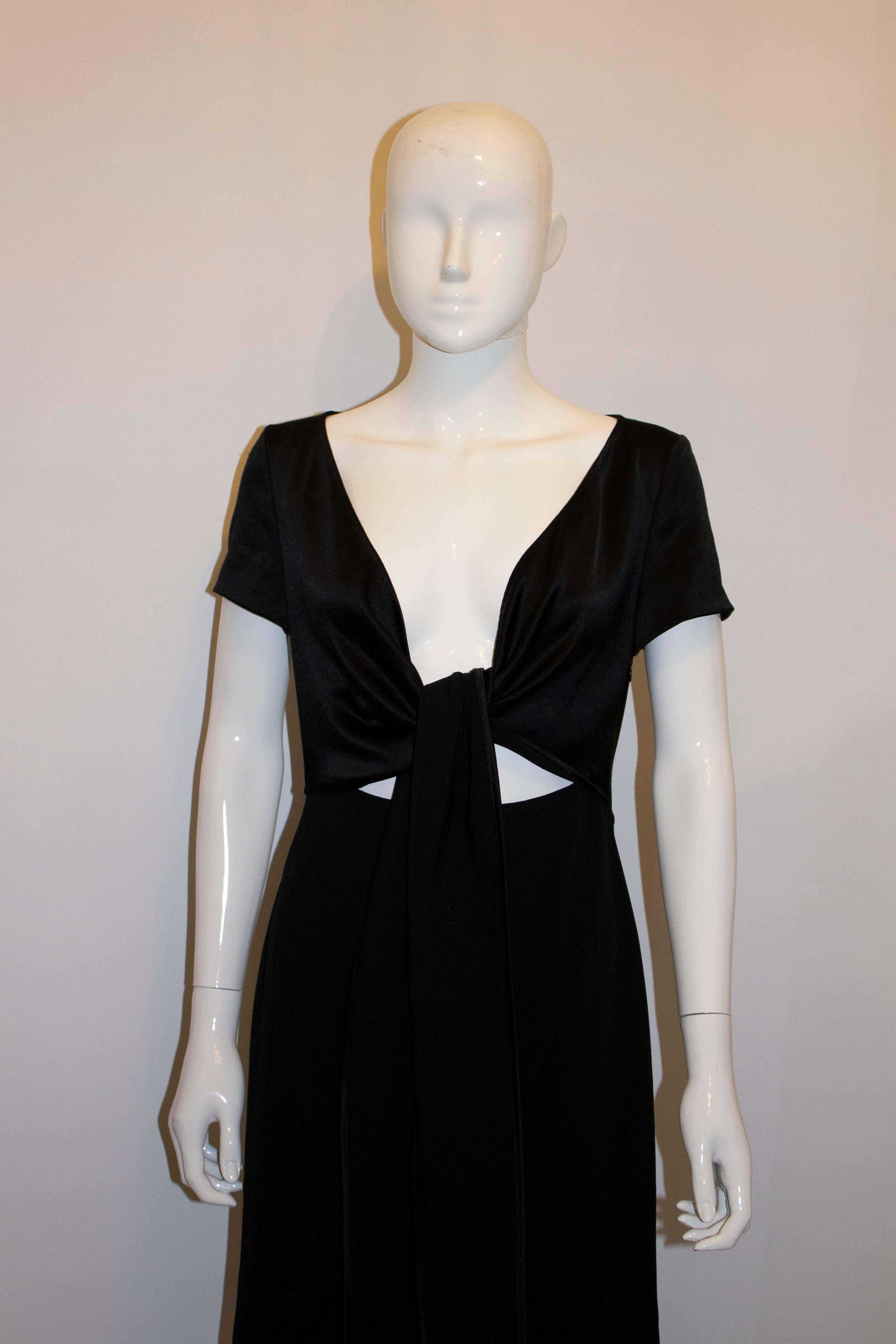 A chic black cocktail dress by Max Mara. The dress has a side zip opening, interesting tie front detail and cap sleaves. UK size 8 Measurements: Bust 34'', length 42''