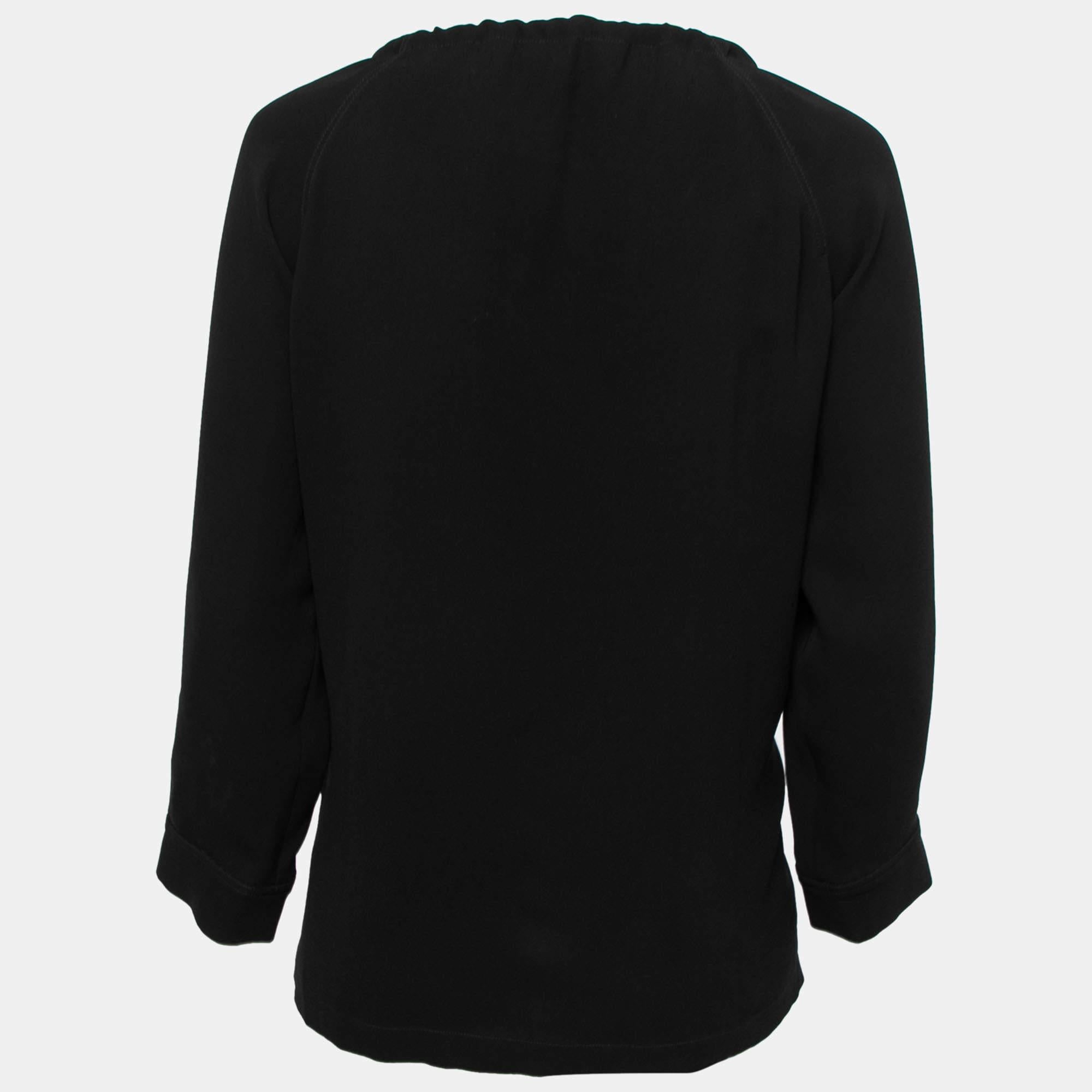 This blouse from Max Mara is stitched from crepe fabric into a flattering design and is truly pretty. The black blouse has a drawstring detail and long sleeves. Pair it with skinny jeans to achieve a balanced outfit.