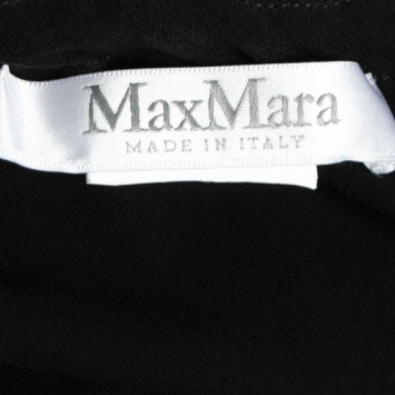 This blouse from Max Mara is stitched from crepe fabric into a flattering design and is truly pretty. The black blouse has a drawstring detail and long sleeves. Pair it with skinny jeans to achieve a balanced outfit.