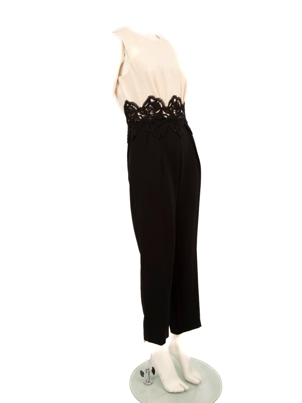 CONDITION is Very good. Minimal wear to the jumpsuit is evident. There is a small mark on the back near the zipper and the right shoulder of this used Max Mara designer resale item.
 
 Details
 
 
 Black
 
 Synthetic
 
 Jumpsuit
 
 Sleeveless
 
