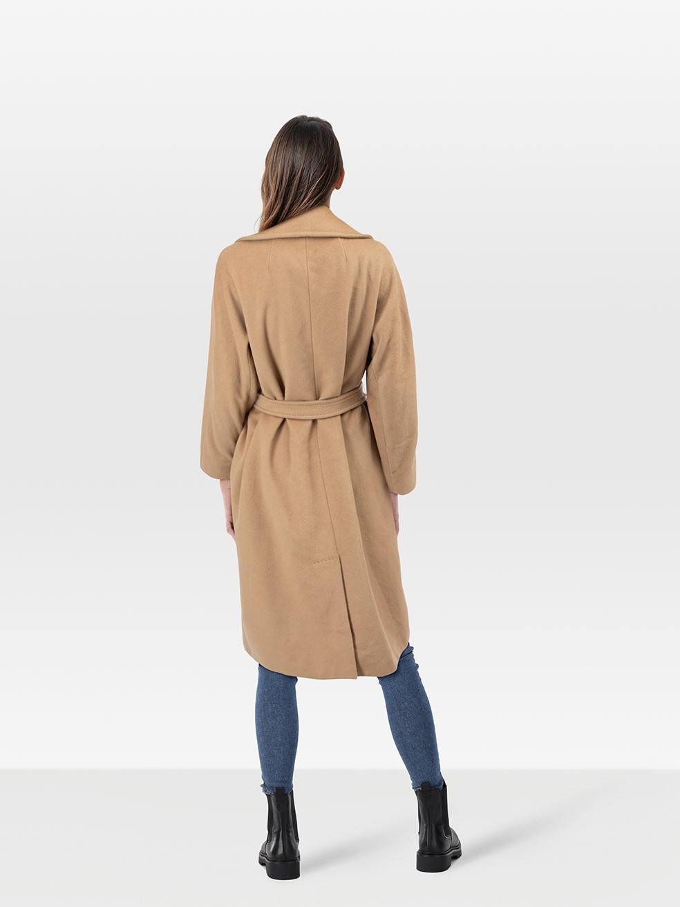 CONDITION is Very good. Minimal wear to coat is evident. Minimal wear to the front inside near the buttons where some small discolouration can be seen. There are some loose threads on the right armpit and moth holes on the back hem on this used Max