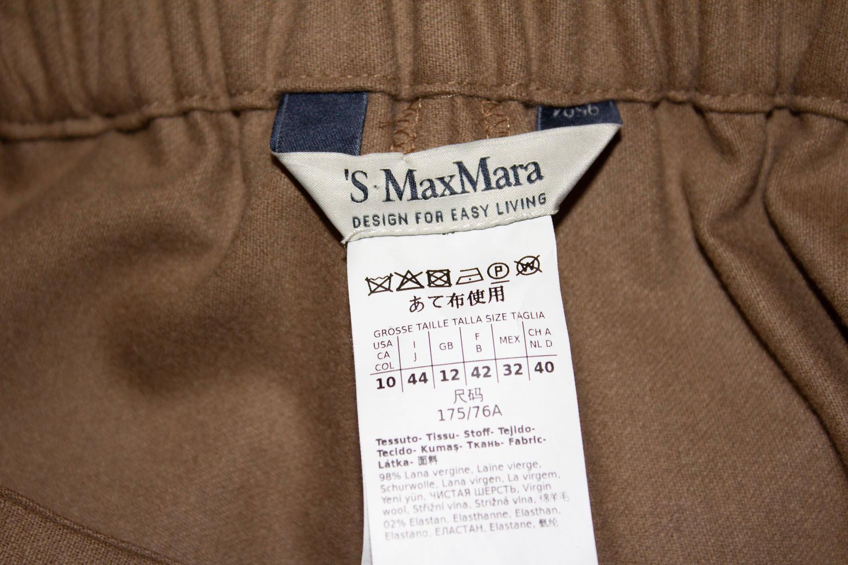  A chic pair of trousers / pants by Max Mara, Easy Living line. As you would expect they are in a super soft wool fabric and pretty caramel colour. 
They have a zip front and elastic back waist. 
UK size 12 . Measurements: Waist 28 /32'' , inside