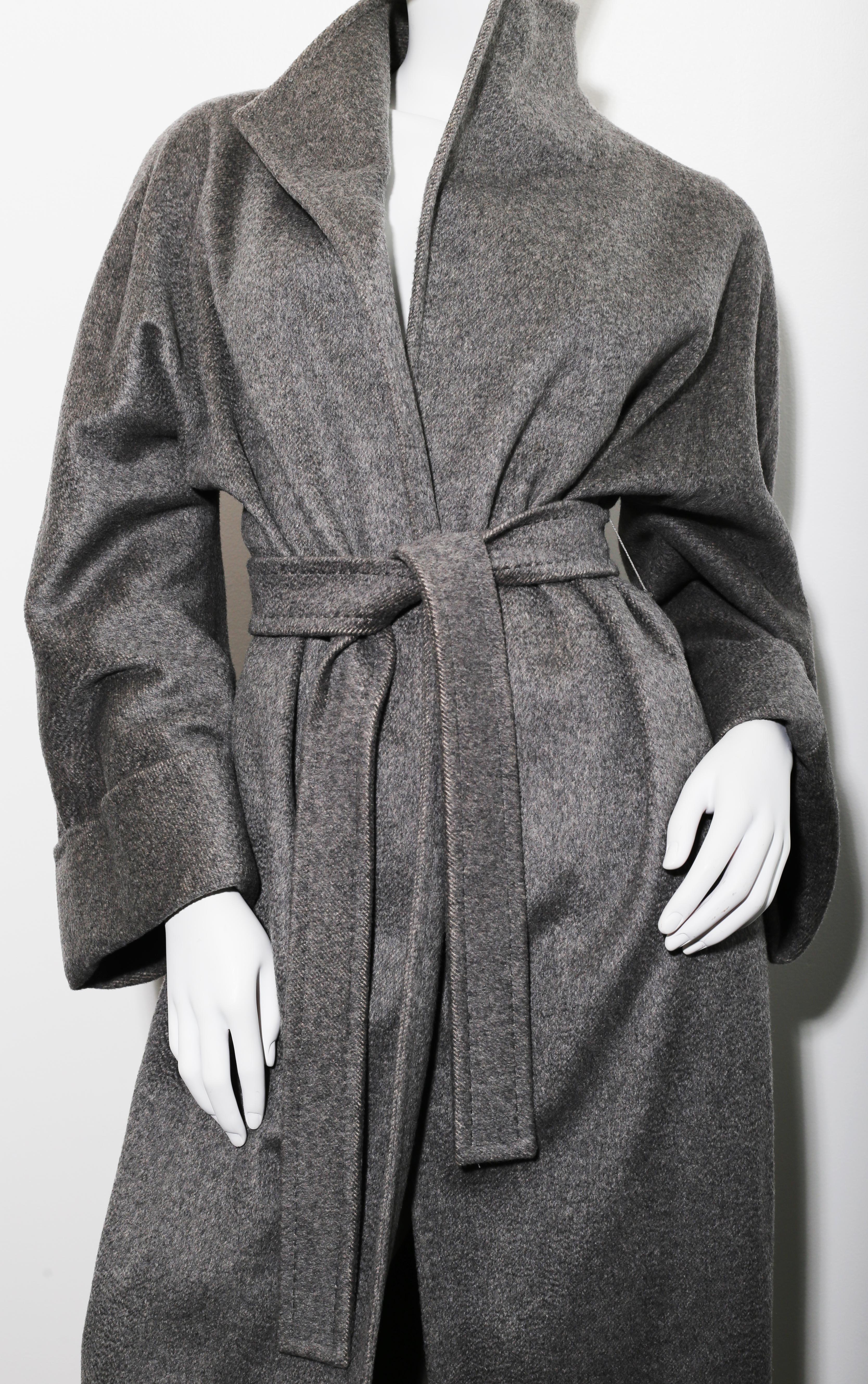 Max Mara Belted Coat is pure luxury defined
Features supremely soft cashmere in timeless grey
 Raglan sleeves, two slanted welt pockets, shawl collar and pick-stitched belt complete this classic look. Fully lined in viscose with oversized 