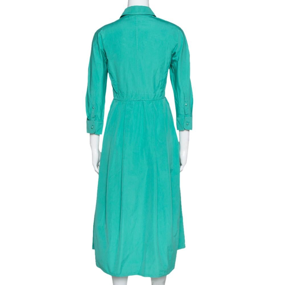 This lovely Max Mara dress will look amazing with statement accessories. It is made of 100% cotton in a shirt style and features pleats below the waist. It comes with concealed buttons and flaunts sharp collars and long sleeves. Pair it with pointed