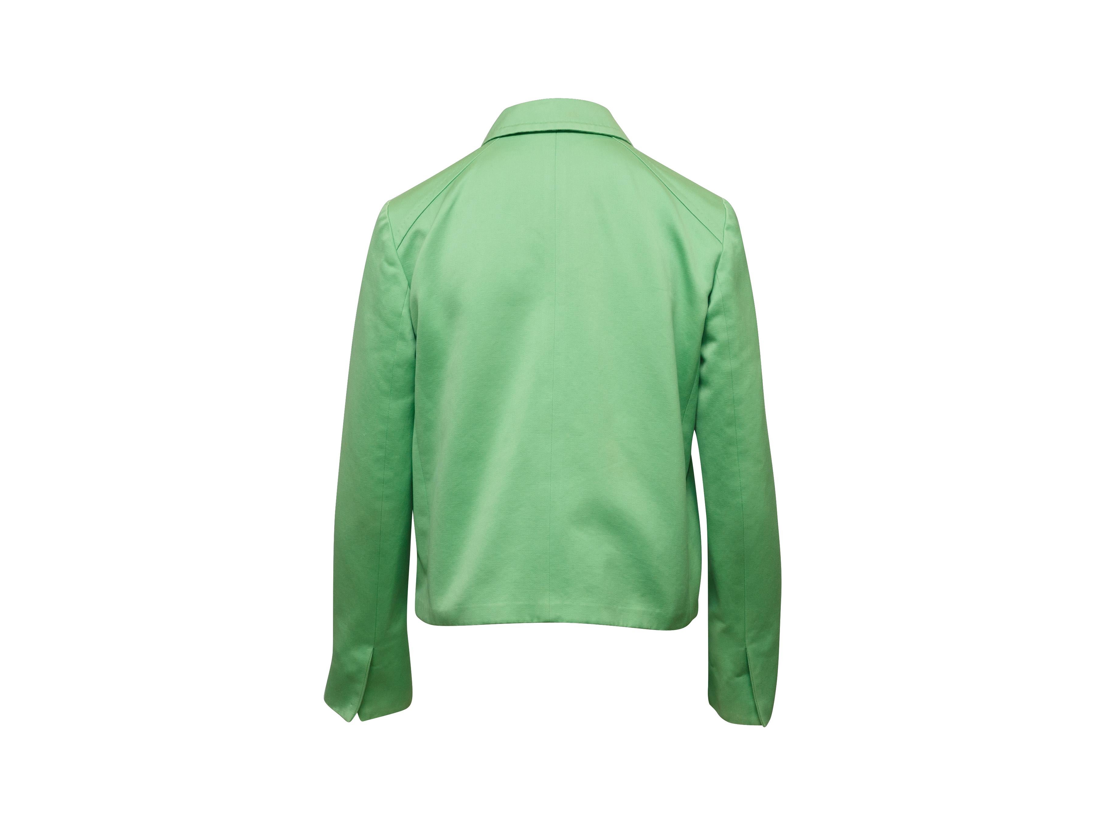 Product details: Green double-breasted lightweight jacket by Max Mara. Pointed collar. Dual pockets. Button closures at front. 32