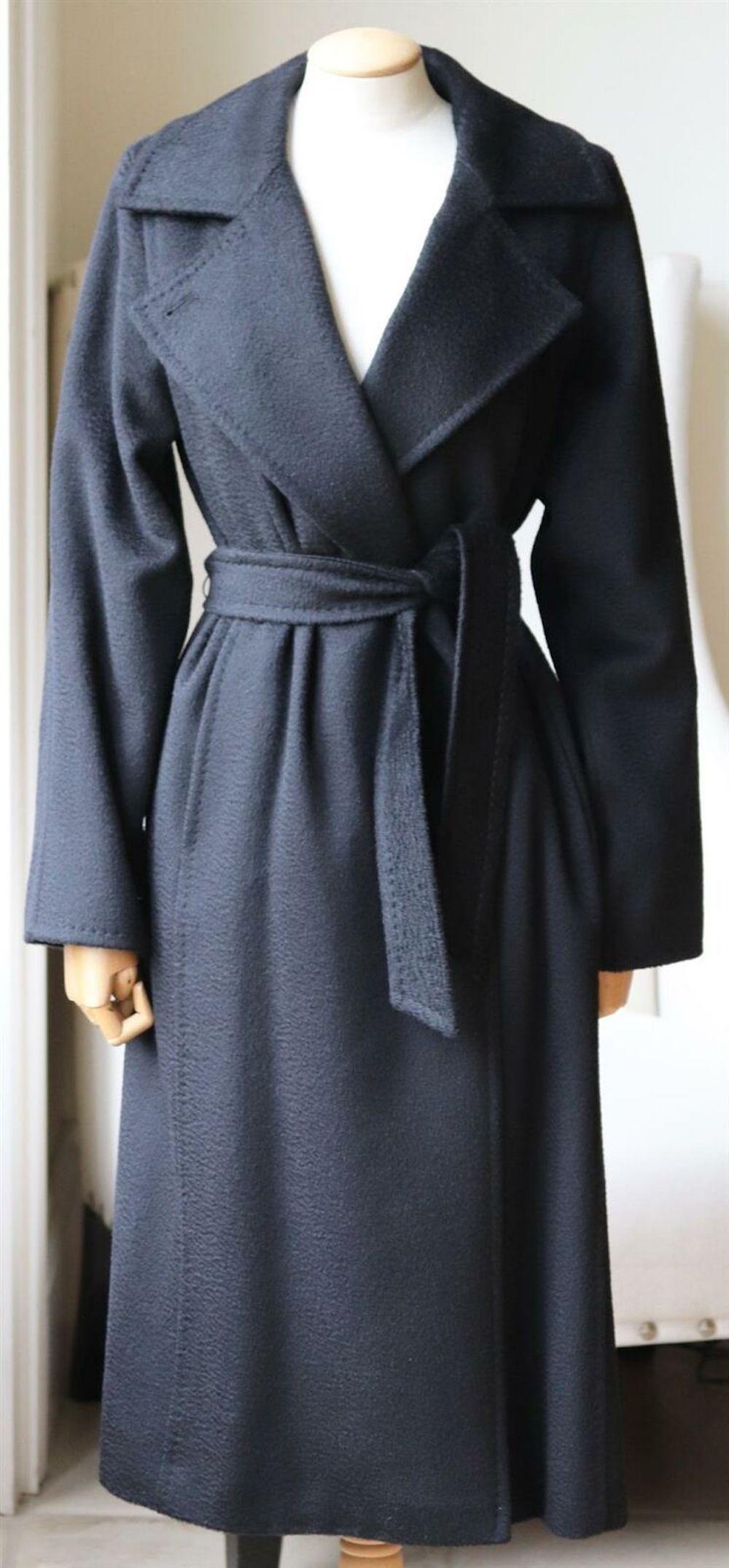 Wearing a Max Mara 'Manuela' coat feels like being wrapped in a cozy blanket.
It's made from super soft camel hair with a plush handle and has a loose fit that's perfect for layering over a chunky knit. 
Black camel hair.
Slips on.
100% Camel hair;