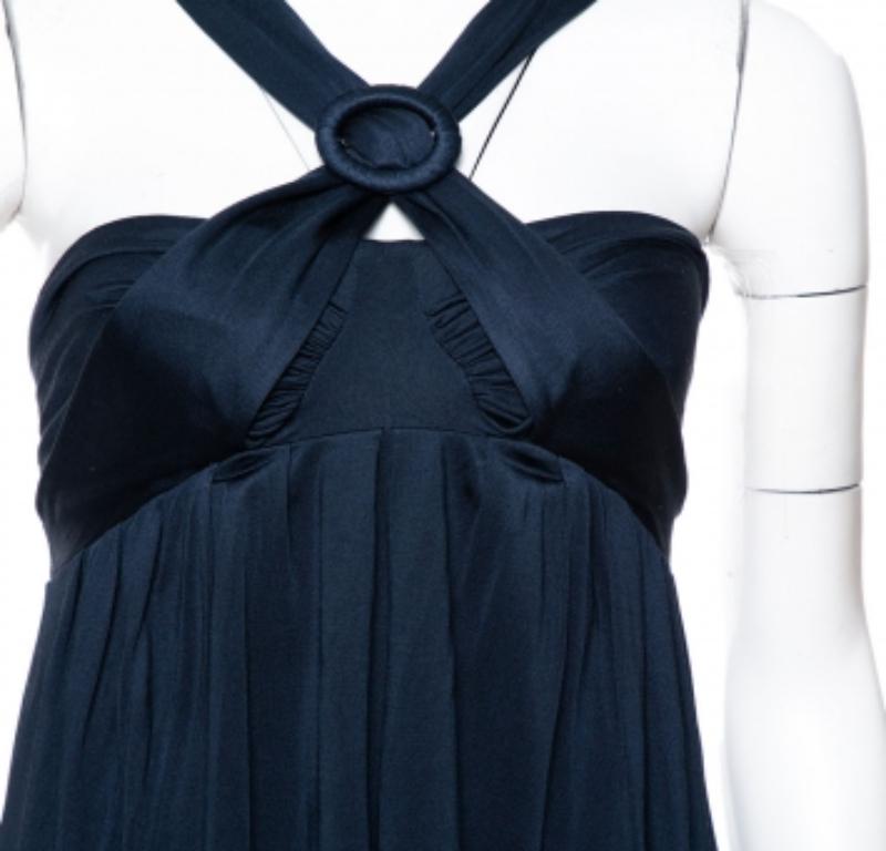 Elegant draping is combined with a flowy silhouette to bring elegance to this stunning halter dress from Max Mara. It has been cut from silk and carries a lovely shade of midnight blue. It has an open back, halter style and a flattering fit. Pair
