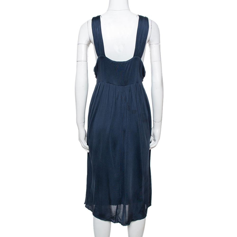 Elegant draping is combined with a flowy silhouette to bring elegance to this stunning halter dress from Max Mara. It has been cut from silk and carries a lovely shade of midnight blue. It has an open back, halter style and a flattering fit. Pair