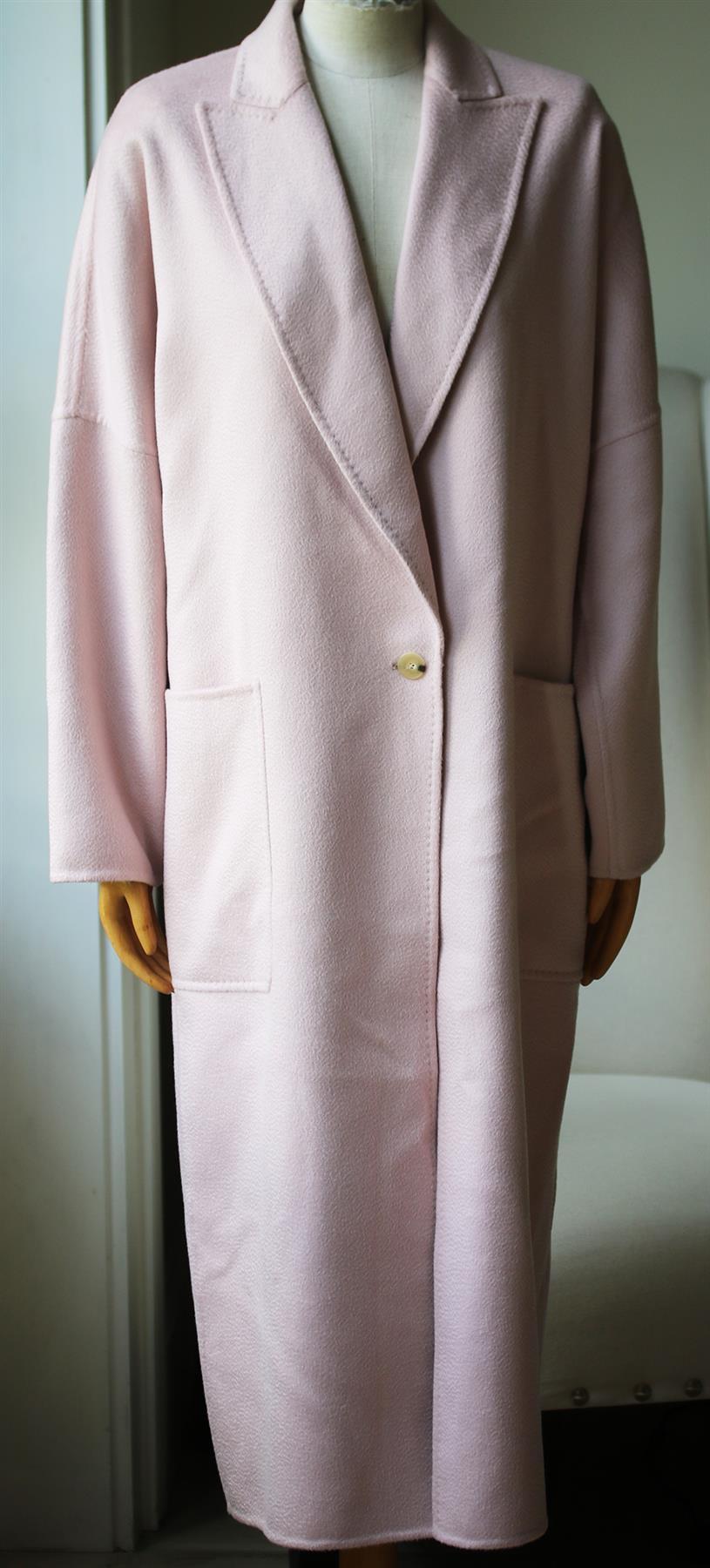 This 'Rubiera' coat by Max Mara is cut from a loose single-breasted shape with wide peak lapels, kimono sleeves, and a martingale strap at the back, and is finished with oversized front patch pockets. Pink cashmere. Button fastening through front.