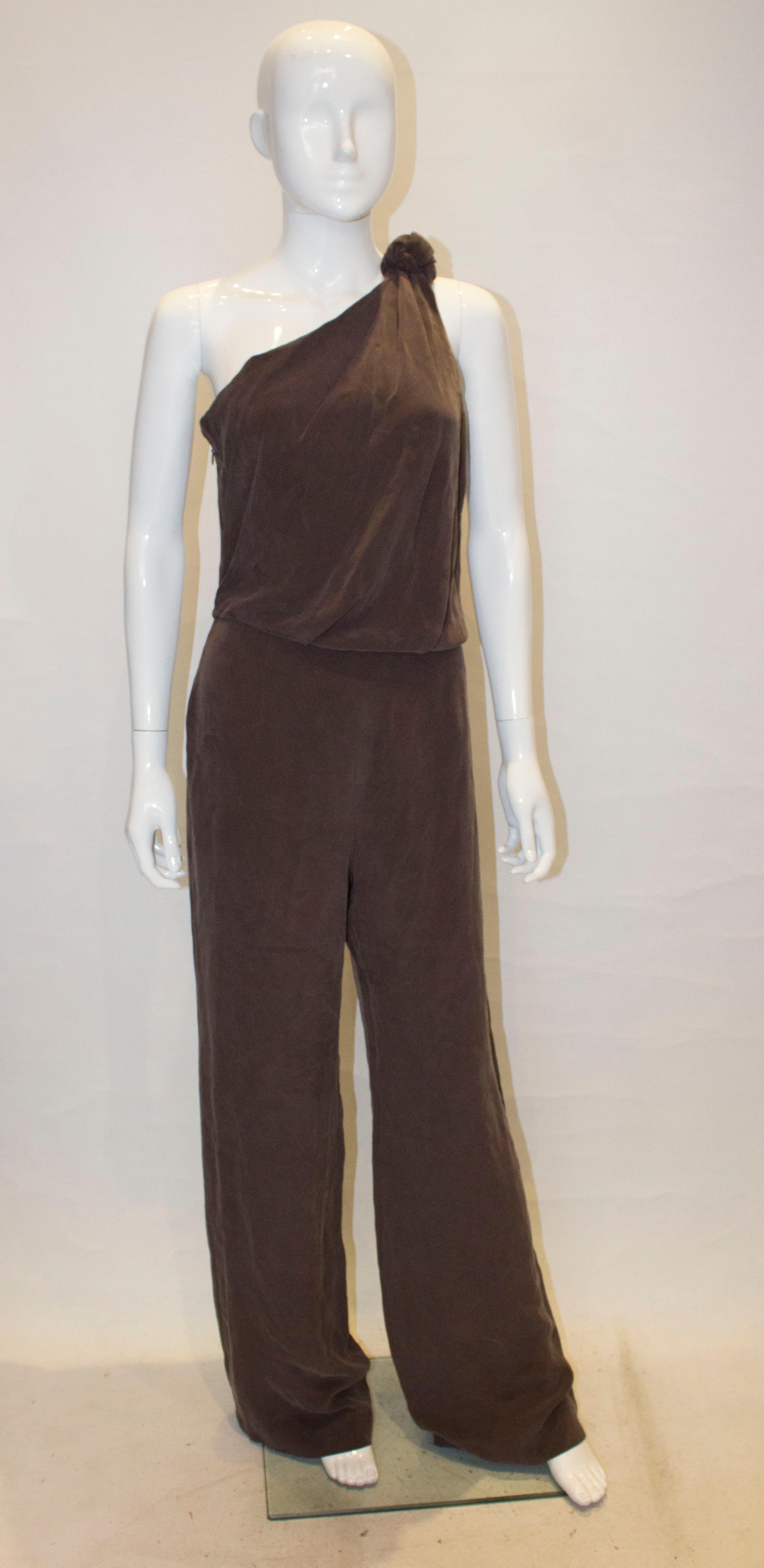 A chic silk jumpsuit by Max Mara.In a chestnut brown the jump suit has a zip opening on the right hand side. Measurements: bust 37'', waist 28'', inside leg 36''