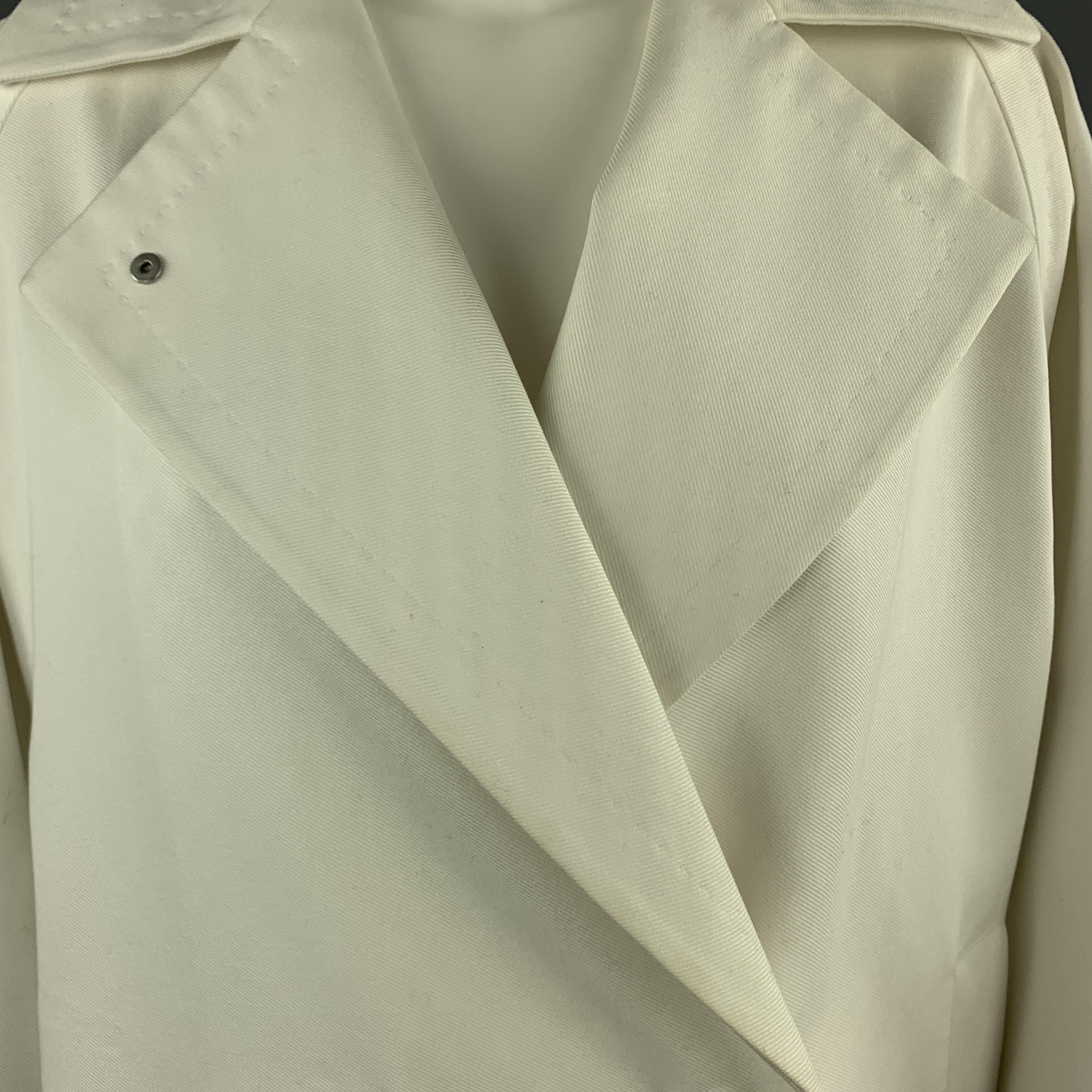 MAX MARA coat comes in off white cotton twill with a pointed lapel, hidden snap double breasted front, raglan sleeves, and elastic drawstring hem. Minor discolorations throughout. As-is. 

Very Good Pre-Owned Condition.
Marked: USA