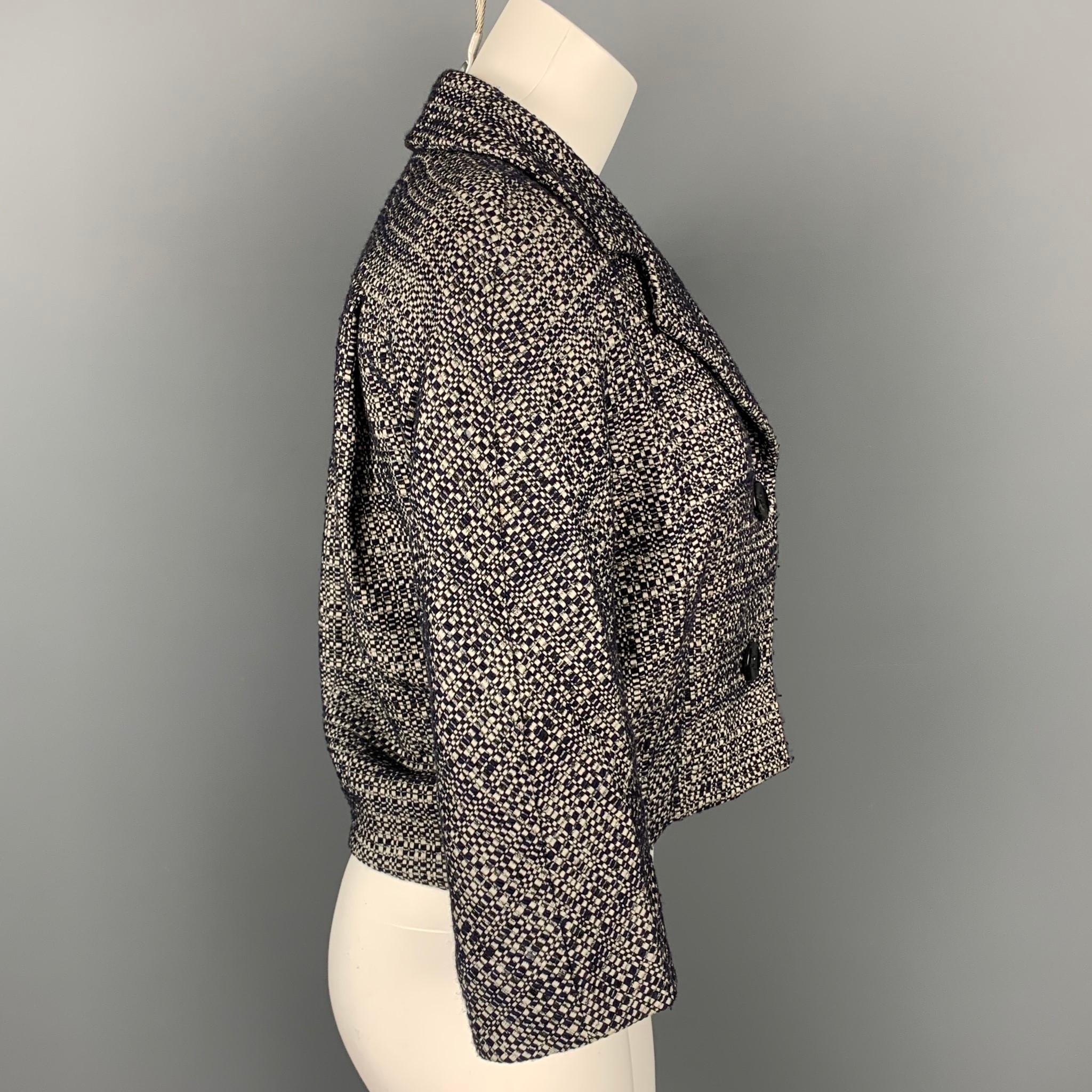MAX MARA jacket comes in a navy & white boucle cotton with a full liner featuring a cropped style, 3/4 sleeves, notch lapel, and a buttoned closure. Made in Italy.

Good Pre-Owned Condition.
Marked: 6

Measurements:

Shoulder: 17 in.
Bust: 38