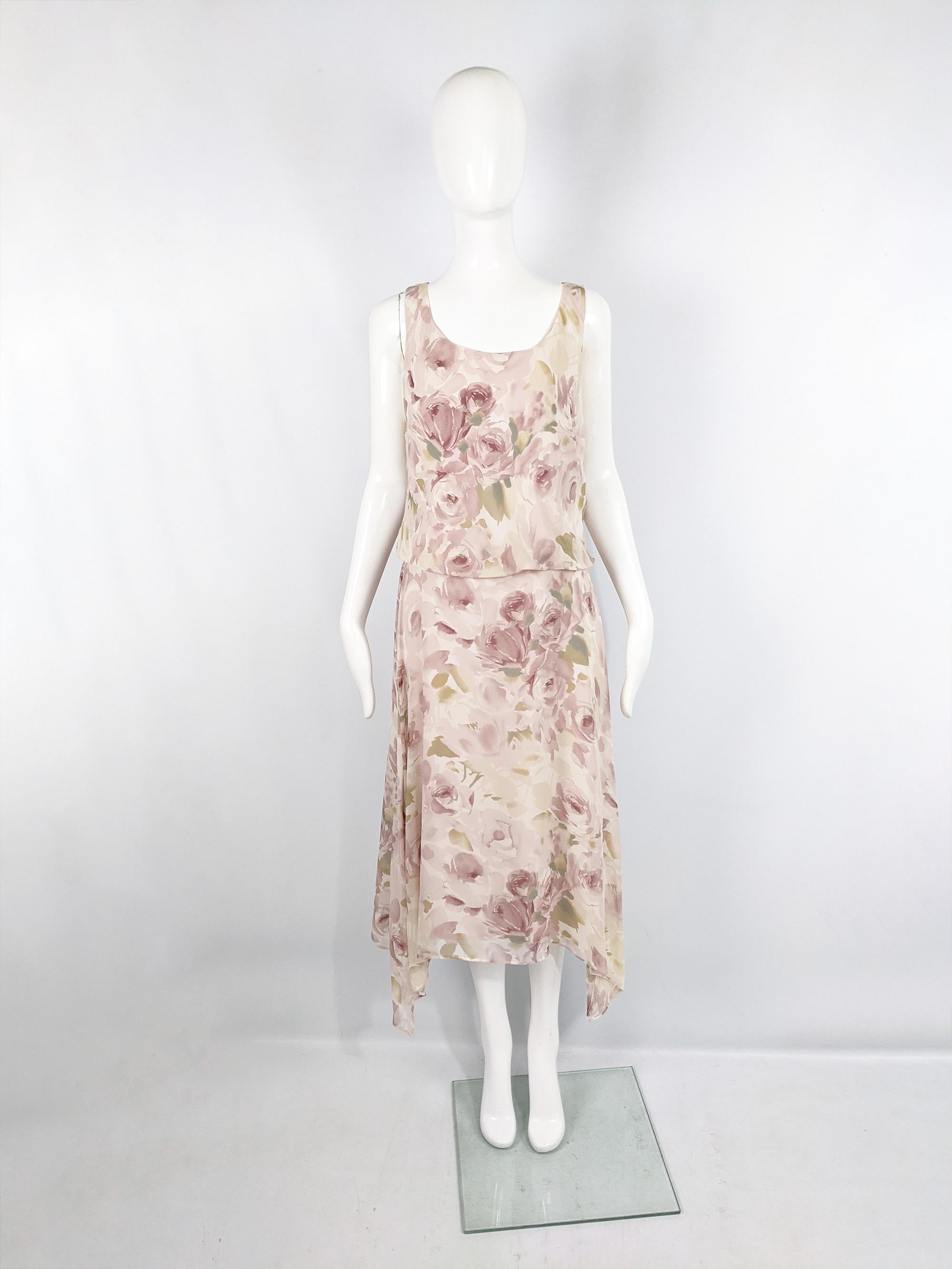 A pretty vintage dress from the 90s by luxury Italian fashion house, MaxMara. In a sheer, pastel pink floral print silk chiffon fabric. It has a loose blouson fit on top with a pointed skirt that is longer at the sides. Perfect for the day in spring