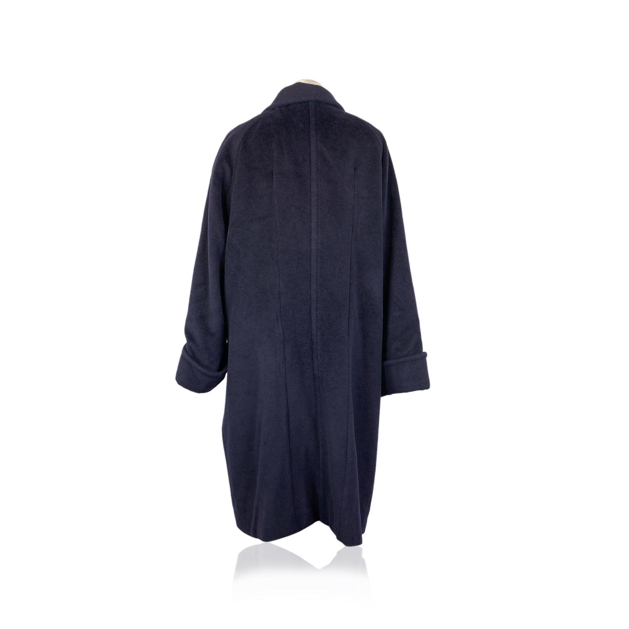 Step into timeless elegance with this Max Mara Vintage Blue Wool Double Breasted Coat. A true statement piece, this coat is crafted with a luxurious warm fabric, offering both warmth and sophistication for colder days (although not indicated, the