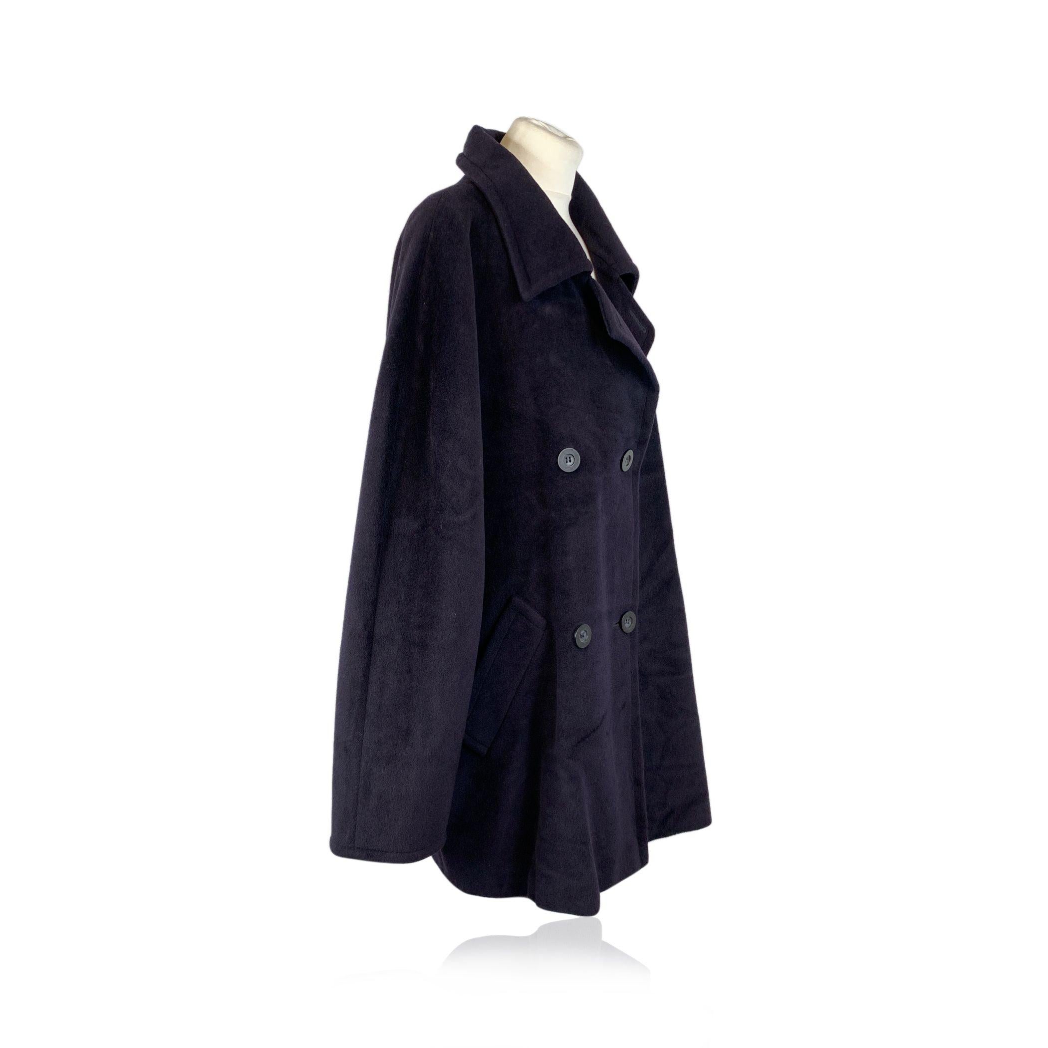 Discover the charm of timeless sophistication with this Max Mara Vintage Blue Wool Double Breasted Coat. Crafted from 100% pure virgin wool, this mid-length coat offers both elegance and warmth, perfect for transitioning through the seasons in