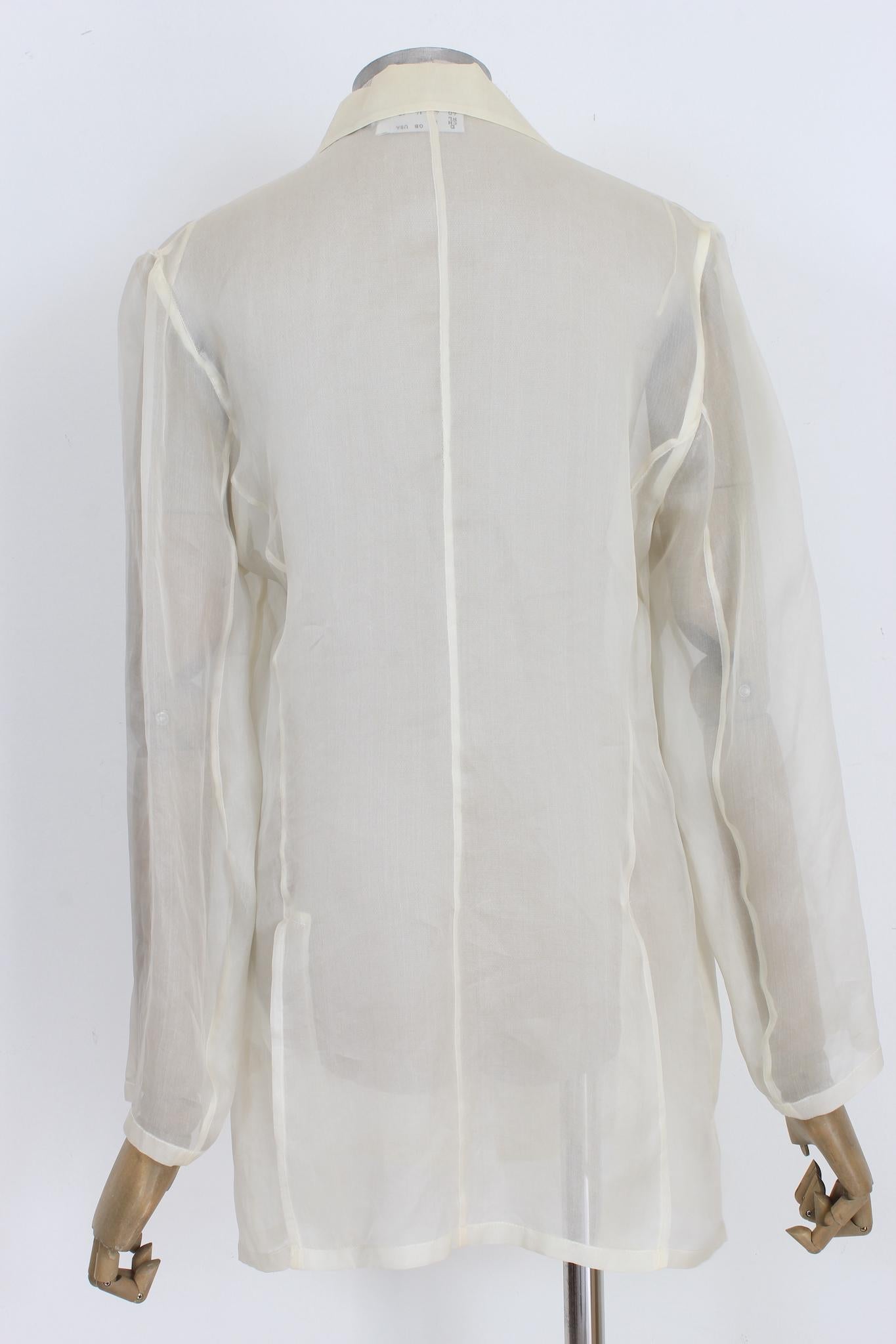 Max Mara vintage 90s evening jacket. Soft overcoat in elegant transparent white color, mother-of-pearl button closure. Two large hip pockets. 100% silk fabric. Made in Italy.

Size: 44 It 10 Us 12 Uk

Shoulder: 44 cm
Bust/Chest: 50 cm
Sleeve: 58