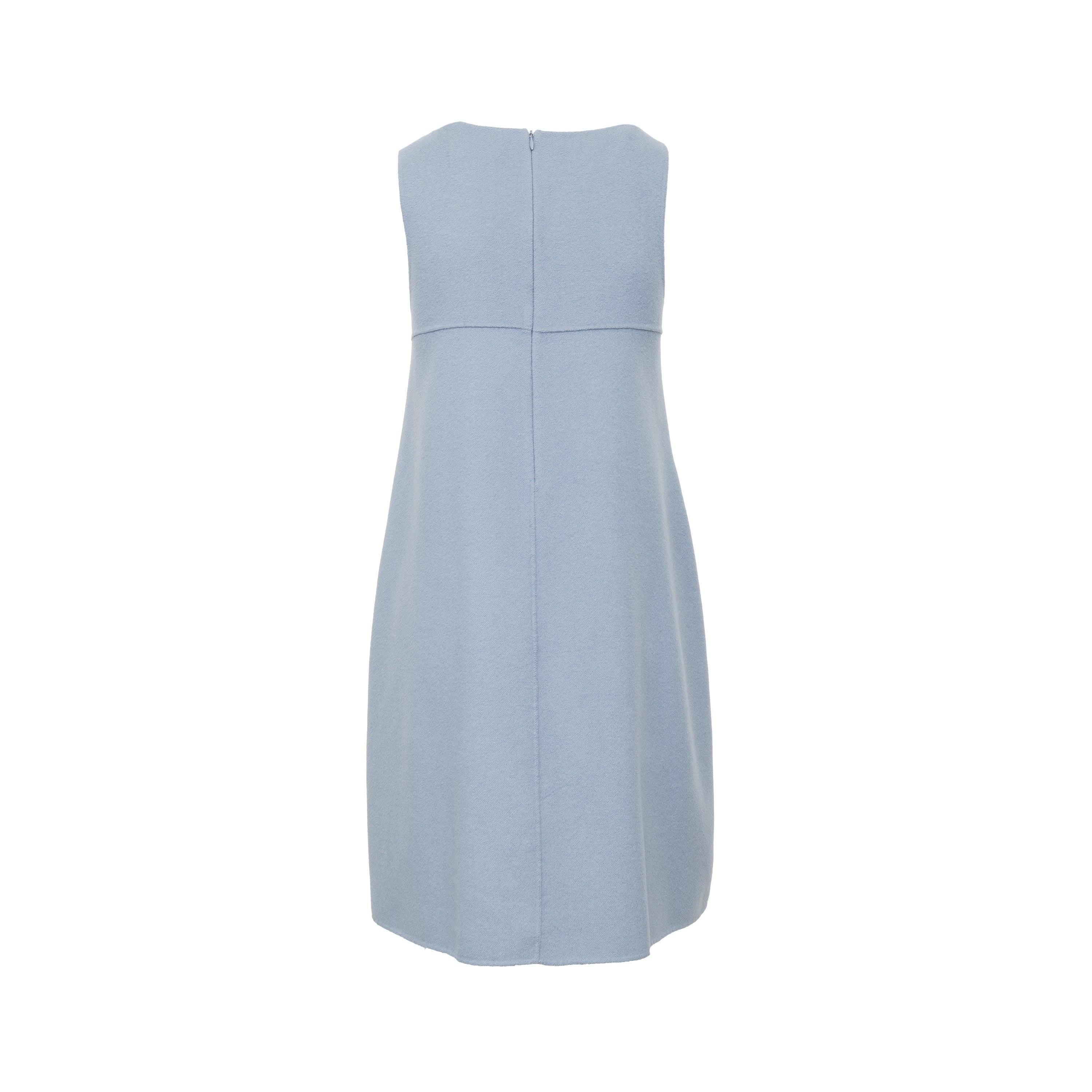 This Max Mara Wool Dress from the 2010s is handmade from luxurious virgin wool in a soft blue color. The flowy hem adds a touch of elegance, and the two pockets provide convenience. Complete with a hidden zipper on the back, this dress is chic and