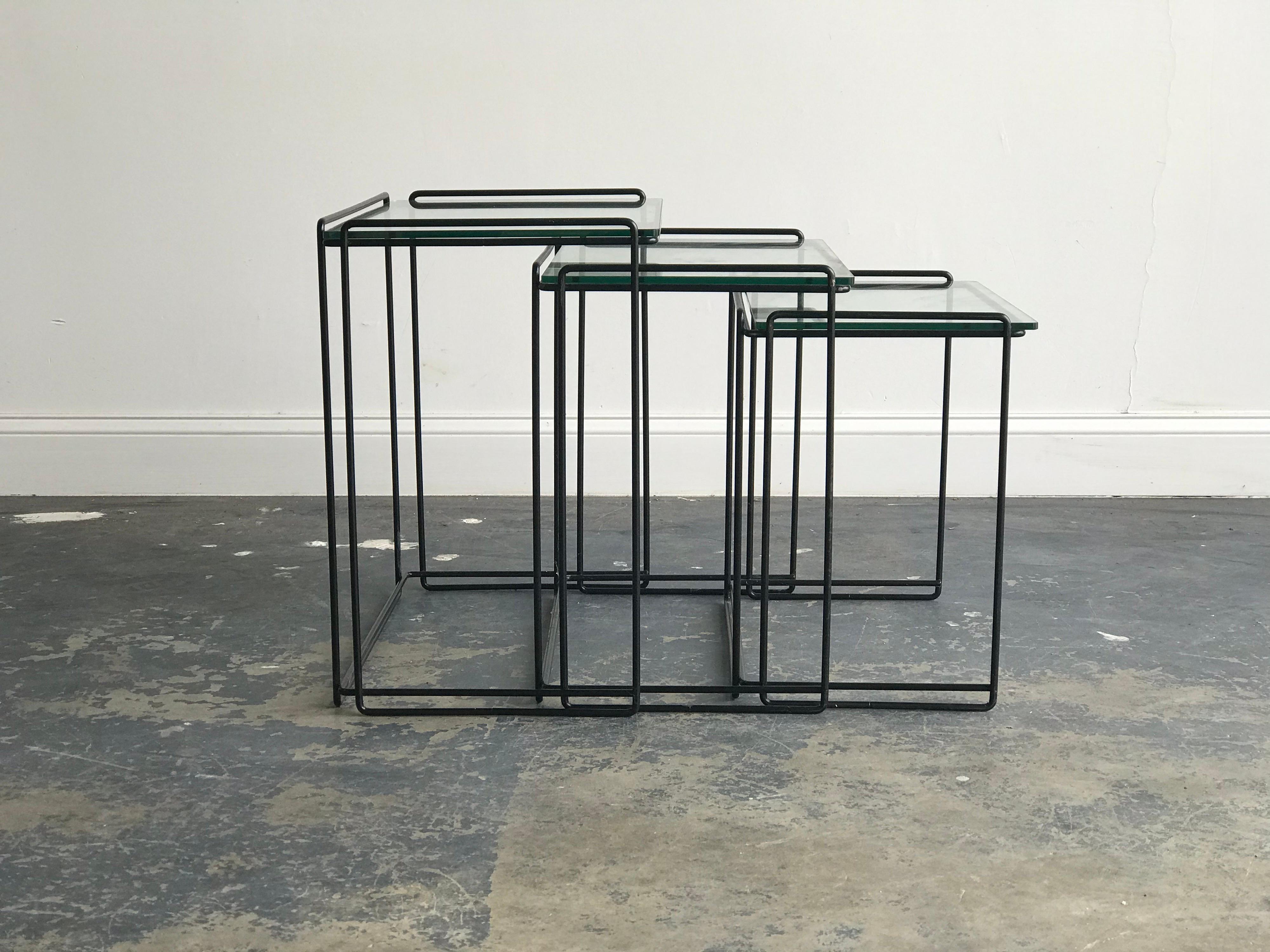 Iron and glass tables by Max Sauze. Wonderful floating design. 

Largest measures: 22 1/2