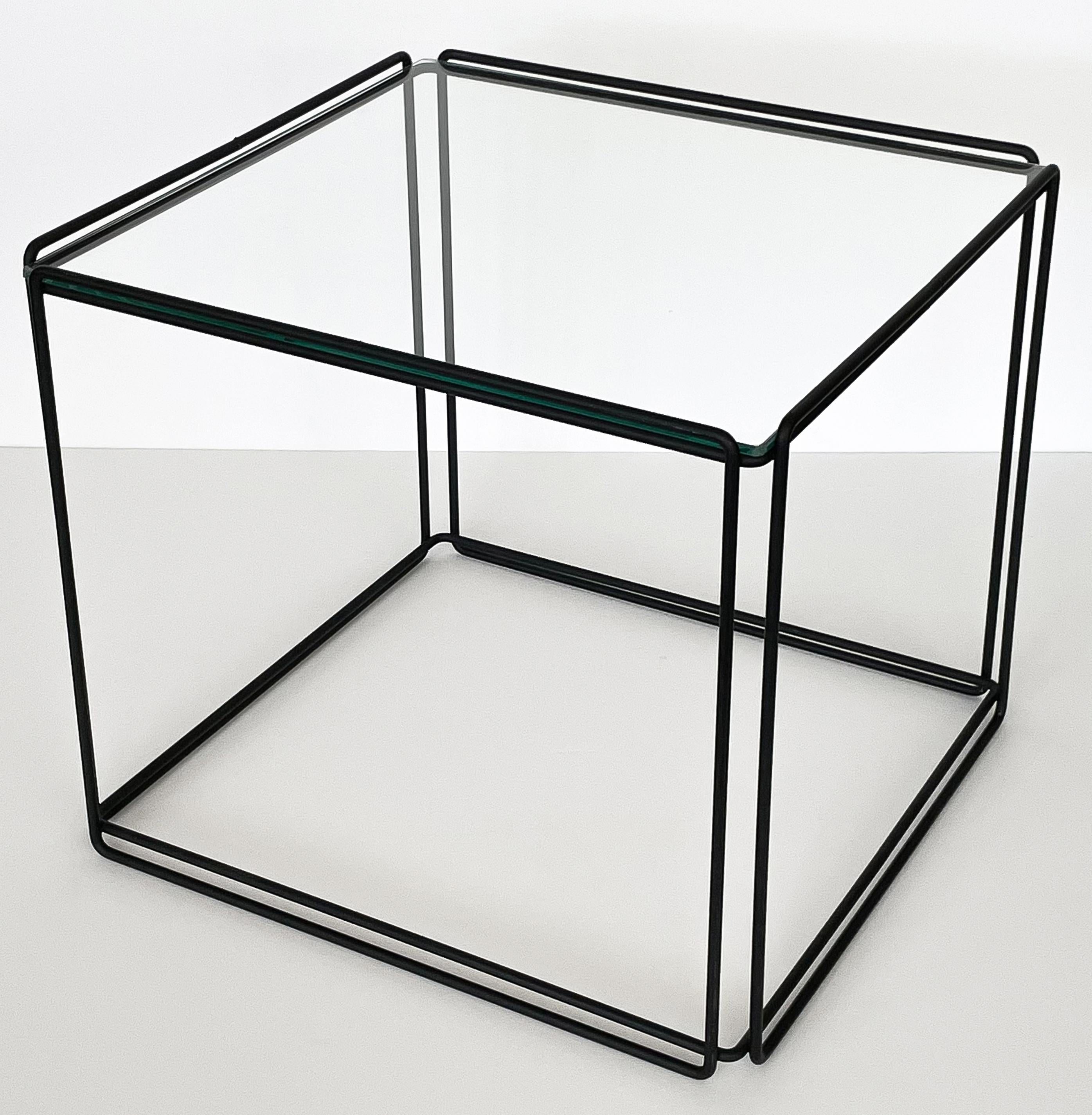 A minimalist metal and glass Isosceles cube side table by Max Sauze for Attrow, France, circa 1970s. Black painted welded wrought iron metal frame with inset 1/4