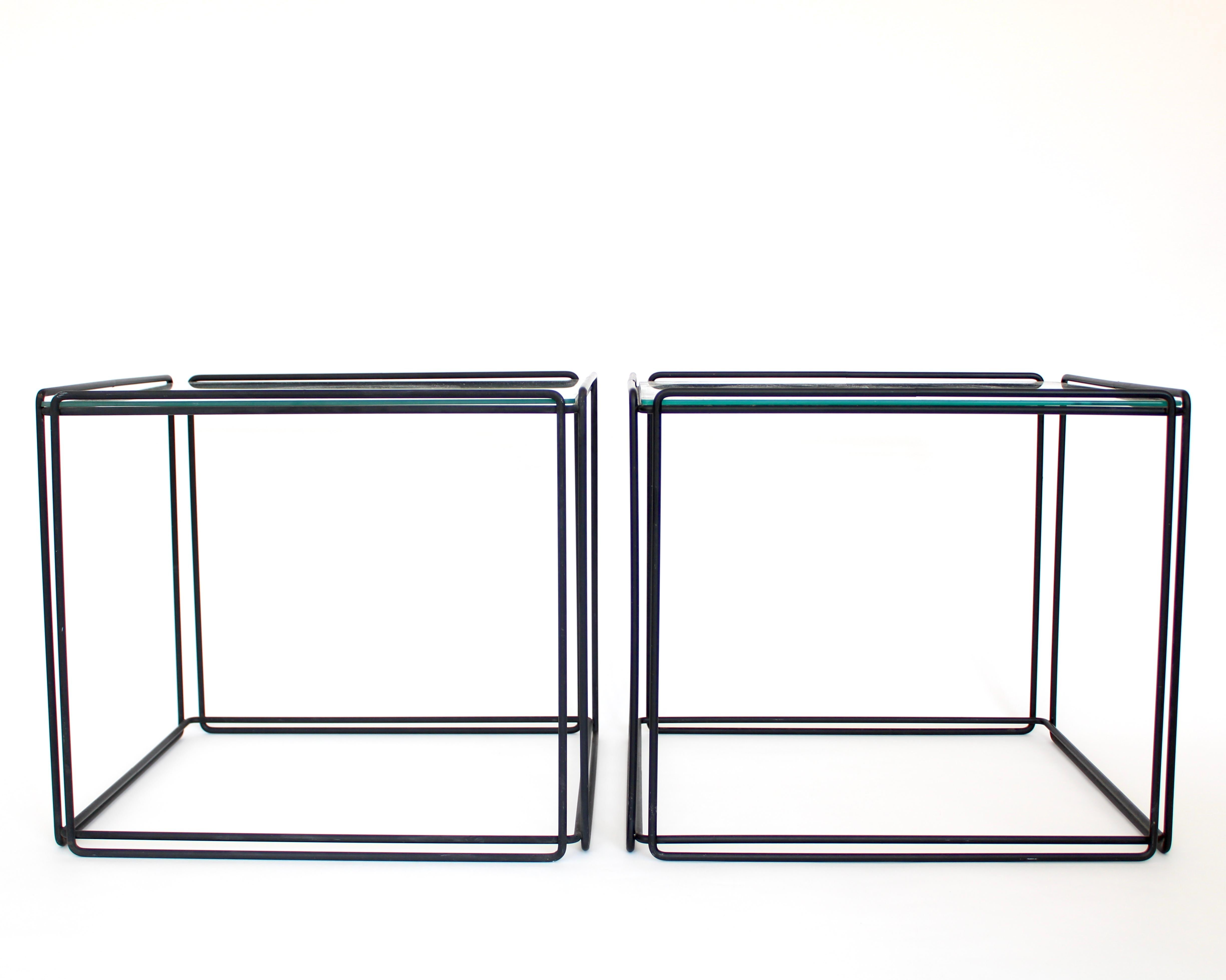 Pair of Max Sauze Isoceles black metal and glass side, end tables or coffee tables for Attro France. 
Circa 1970. The geometric shape gives the name to the tables. Very graphic in design makes these easy to incorporate in any interior. 
These