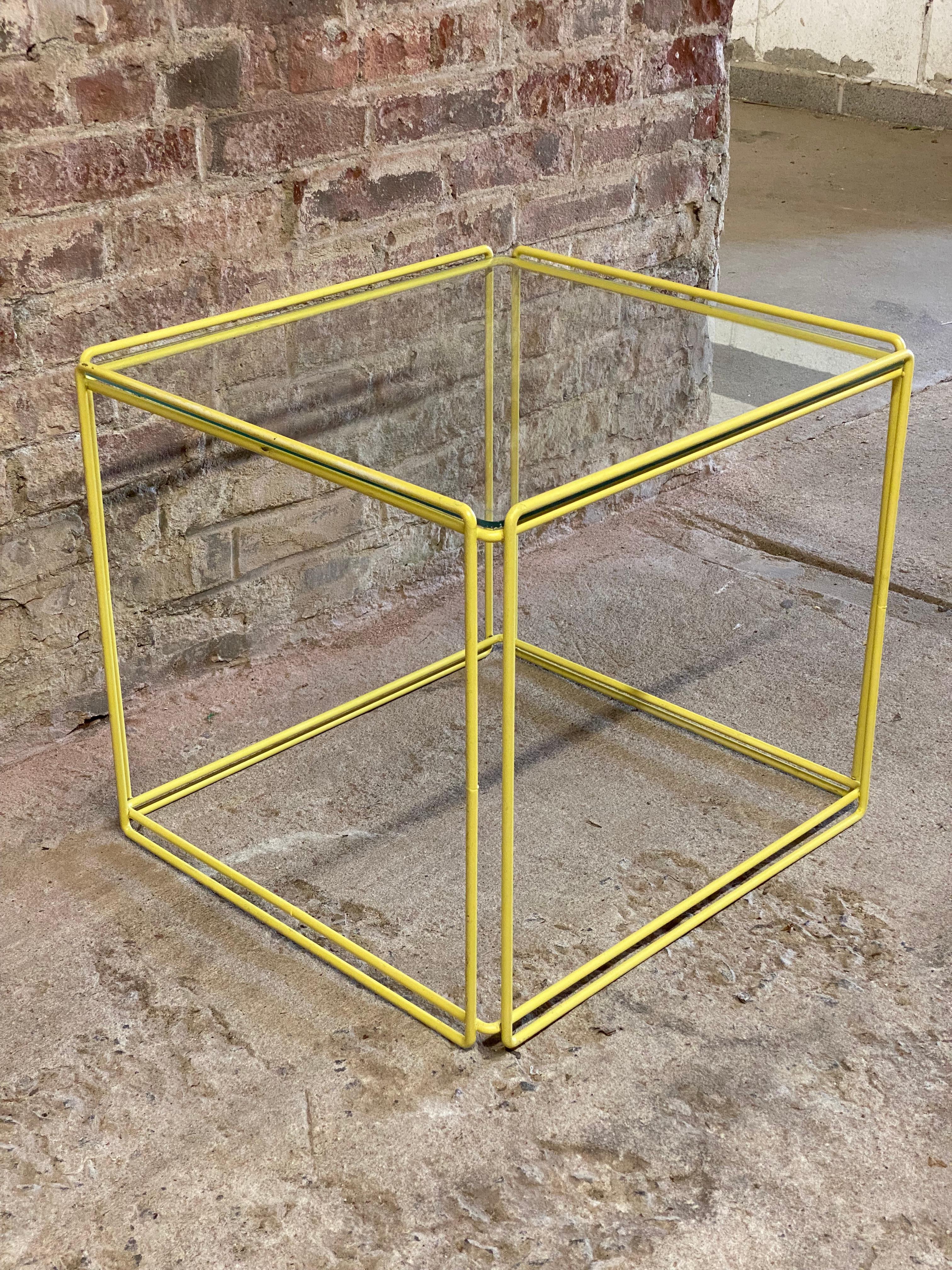 Post-Modern French design by Max Sauze. The Isosceles table is an iconic presence in modern interiors. Circa 1970-80. Steel rod construction with the original glass. Done in a pastel yellow. Good overall condition with minor wear, scuffs and