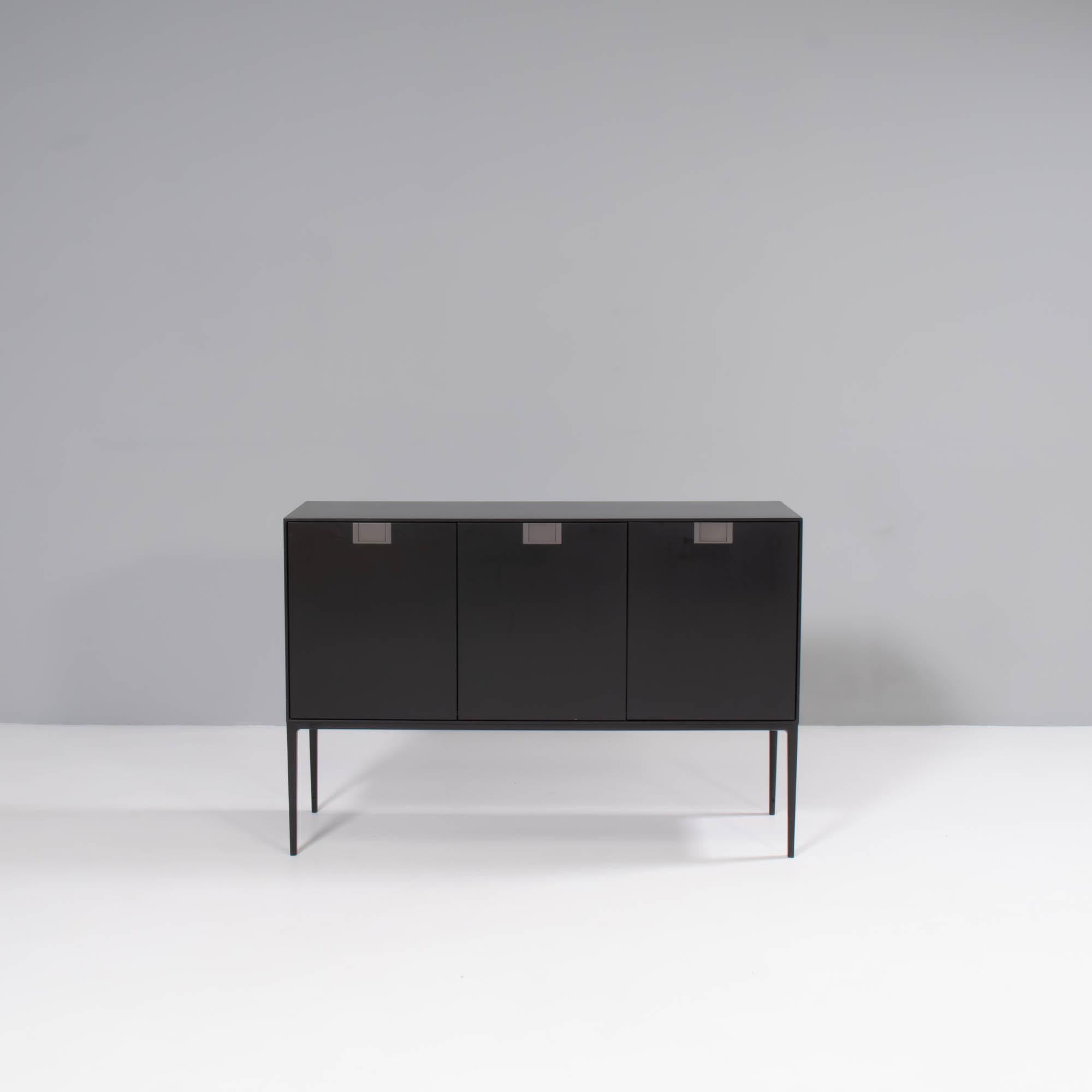Designed by Antonio Citterio for Maxalto in 2014, the Alcor range is a fantastic example of sleek contemporary design.

This LX12 model has a black shellac finish and features 3 cabinet doors with bronze nickel painted door handles.

Offering a