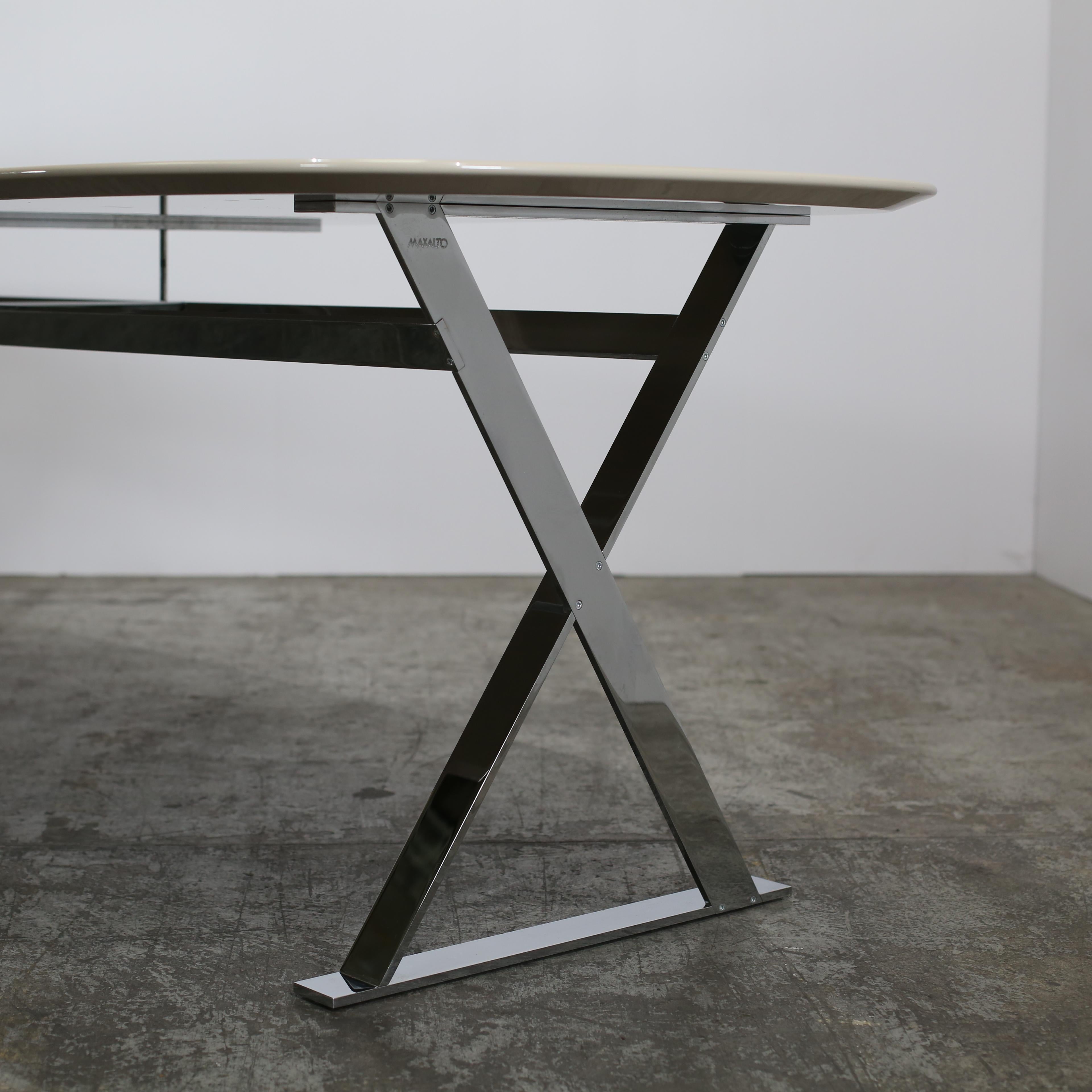 Introducing the Pathos Elliptic Table by Maxalto, a stunning addition to any luxury living space. Crafted with precision and elegance, this table features a sleek elliptic shape and a smooth glossy finish, exuding sophistication and refinement. The