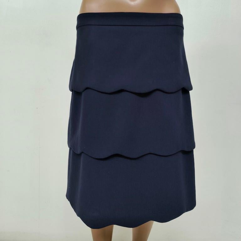 This MAX&Co. navy-blue midi skirt delivers a sophisticated balance of structure and fluidity. Three scalloped tiers fall in crisp, architectural waves, creating gentle movement while lengthening the figure. A flat, dart-free waistband sits just