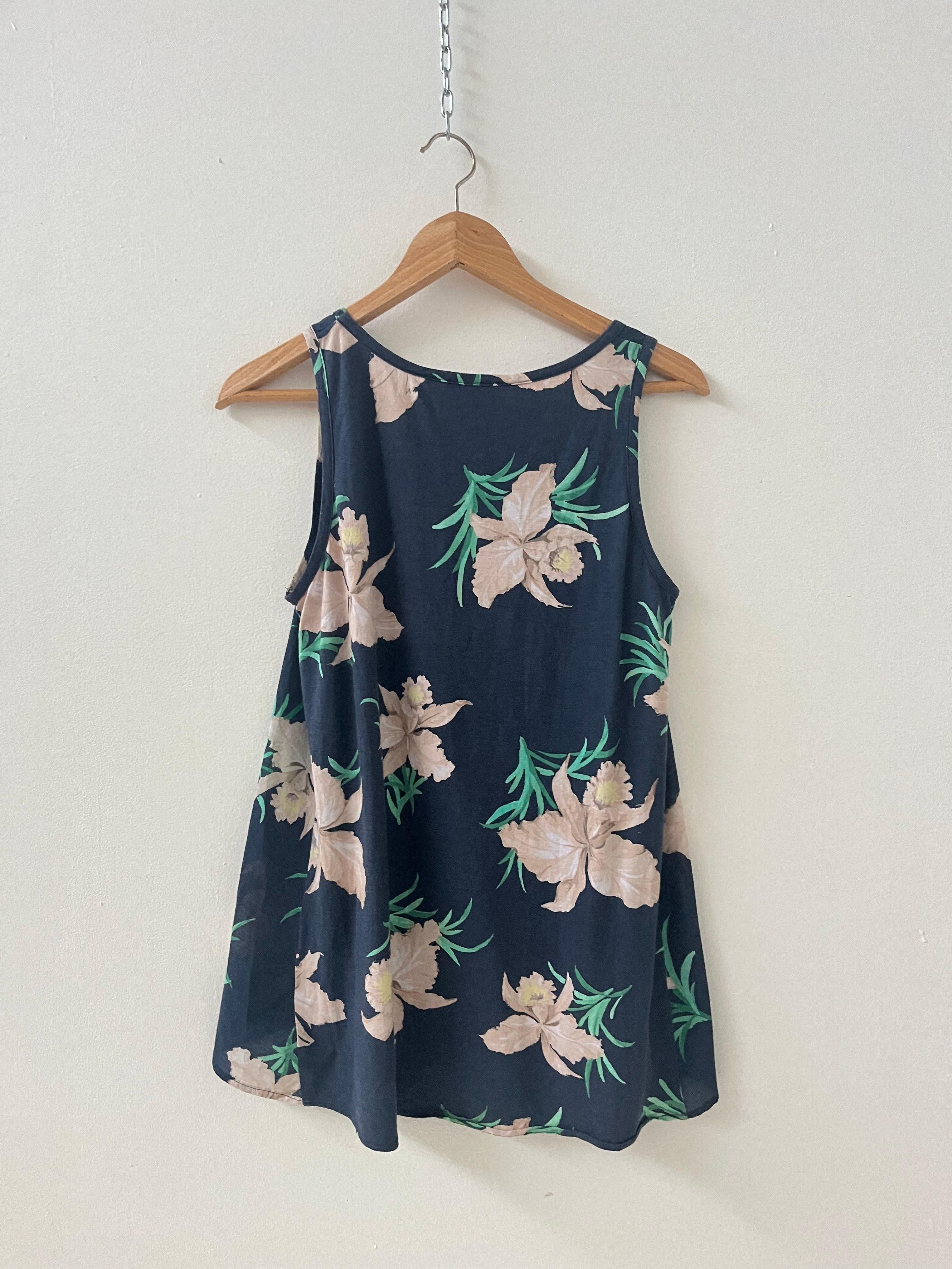 This elegant sleeveless top by MAX&Co. is a perfect example of Italian casual sophistication. Made in Italy, the piece features a flattering A-line silhouette in a lightweight, fluid fabric. The rich navy background is adorned with a delicate