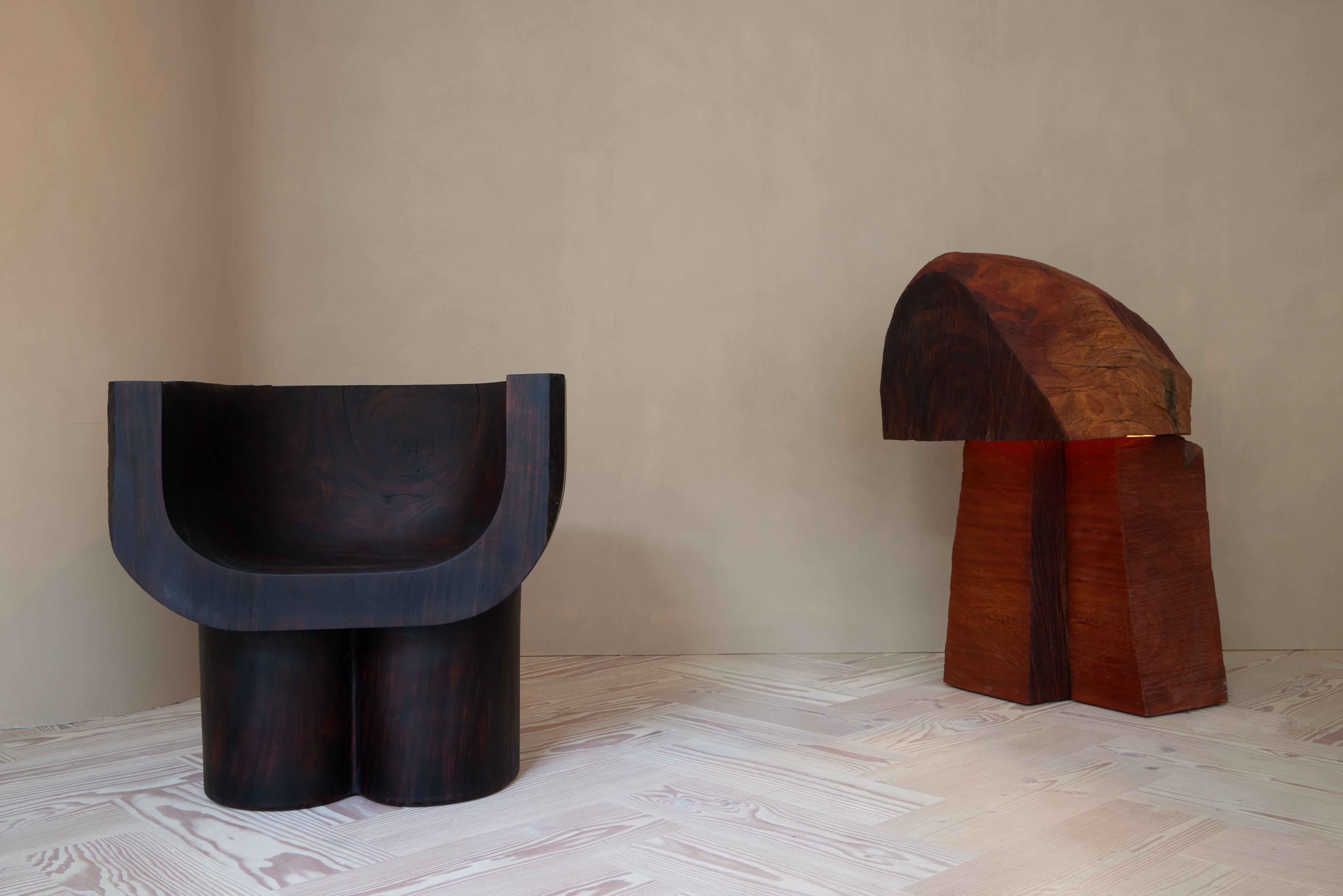 Rodriguez's Maxed lamp hand-carved from Mahogany, salvaged on the island of Puerto Rico after the devastating hurricane of 2017. Allowing the raw wood to speak for itself, the piece also includes a separate plaster reflector which nestles in the