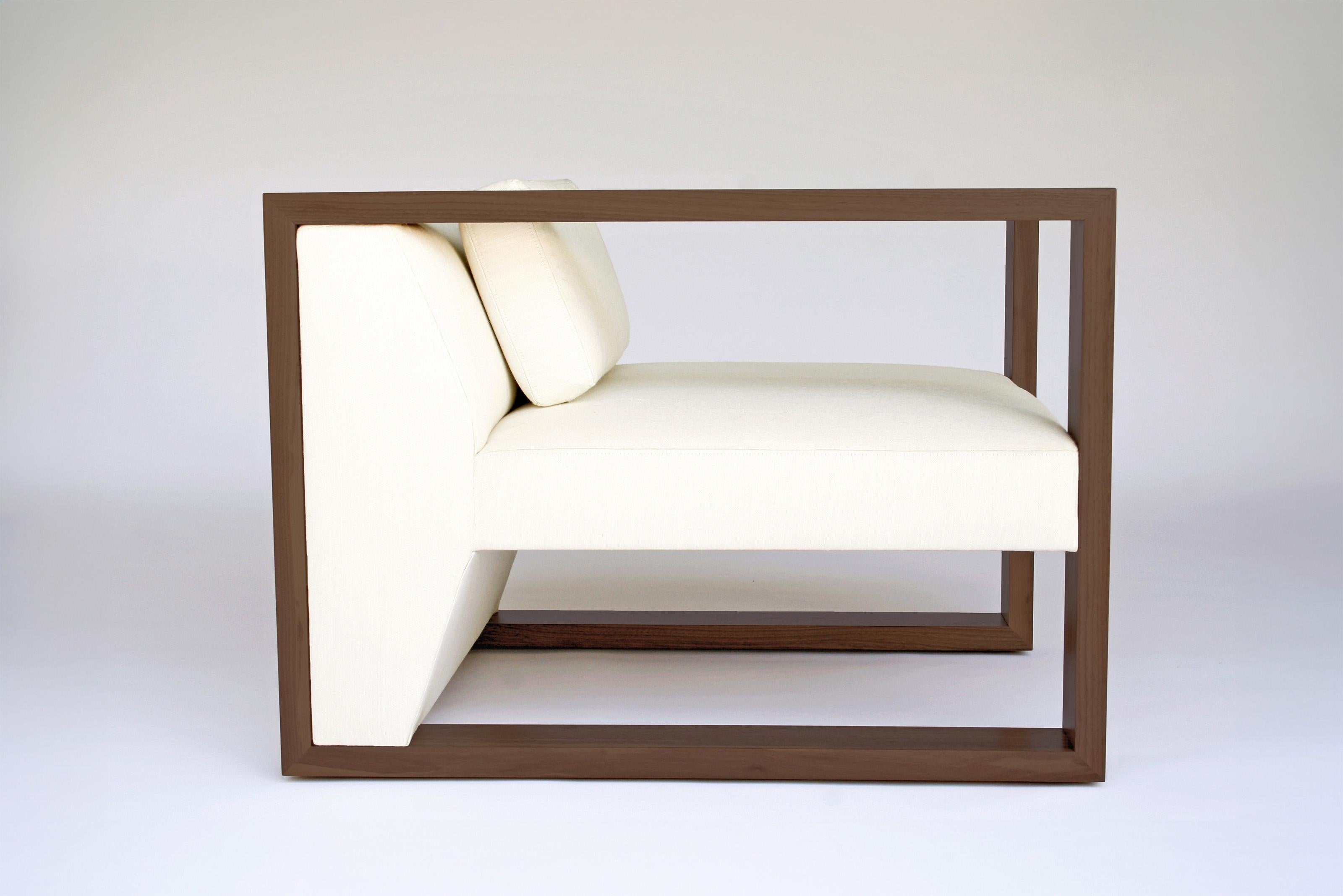 Maxell Chair by Phase Design
Dimensions: D 91.4 x W 76.2 x H 66 cm. 
Materials: Upholstery and solid walnut.

Solid lumber with upholstered body, available in walnut, white oak, or ebonized oak. Upholstery may be sourced in Customer Own Material
