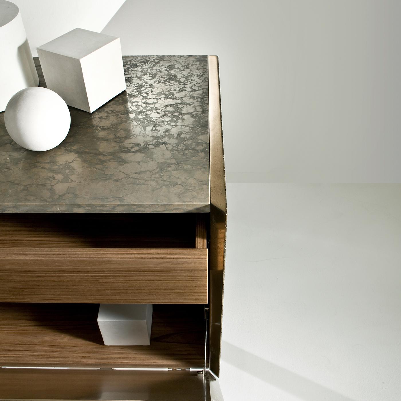 This superb sideboard is part of the Maxima Collection, distinctive for its rigorous geometric silhouette and stunning front and side panels. The Gris Vignè marble top is complemented by the remaining Canaletto walnut structure, internally equipped