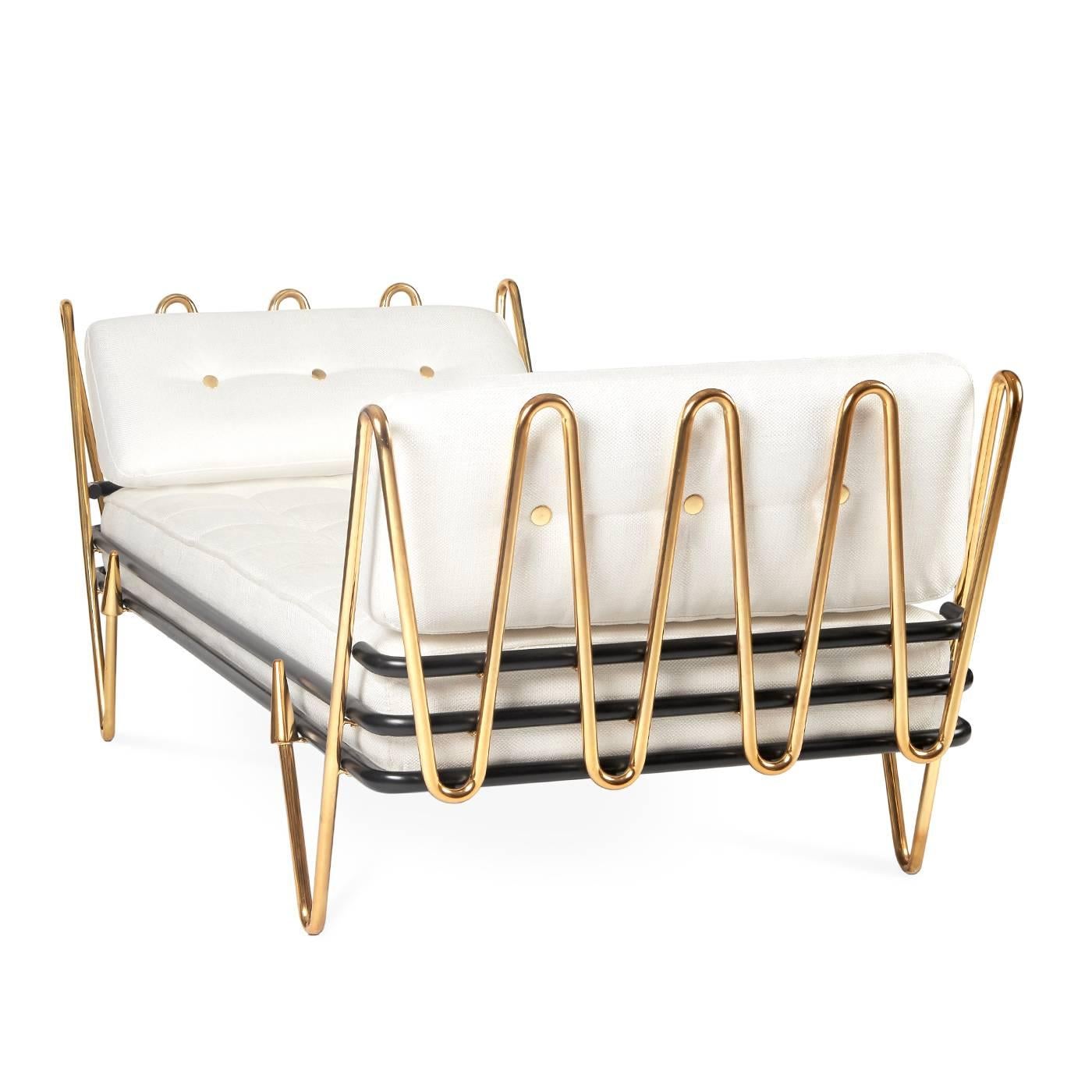 Modern elegance. Sinuous, sculptural, surprising, our Maxime daybed hits all the right notes. A gleaming brass frame cradles a gracious and soft cushion upholstered in a Palermo Dove basketweave. Arrow sabots and shiny brass buttons crank up the