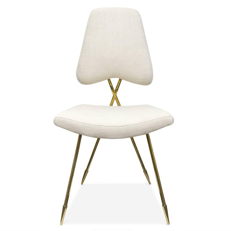 Modern elegance. A gleaming brass frame with an intriguing crisscross back and our signature sabots cradles a softly curved seat and sculptural back. But don't be fooled by the sinuous frame—the Maxime Dining Chair is very comfy. Upholstered in