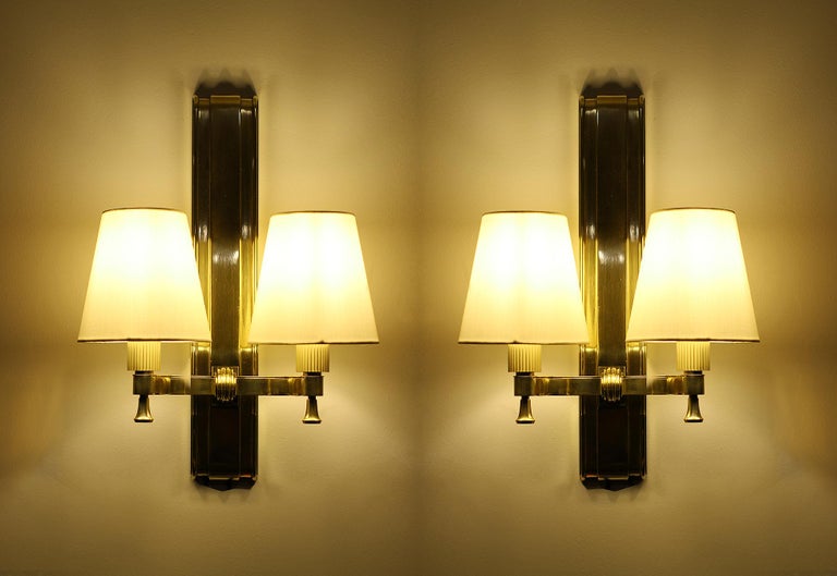 Maxime Old (1910-1991).

Two exceptional polished bronze & brass pair of sconces.
When the sconces are turned ON at night different colors of the bronze appear to make visible the different patinas,

France, circa 1946.

Excellent condition,