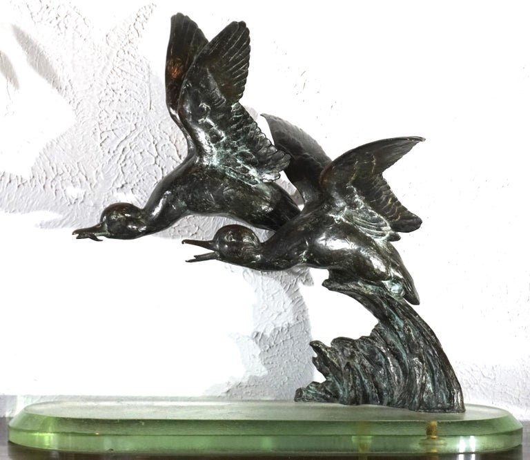 Maximilien-Louis Fiot (1886-1953) Art Nouveau-Art Deco sculpture of Ducks in Flight, patinated cast bronze sculpture mounted on thick Acid etched glass base, impressed signature on lower edge of water 