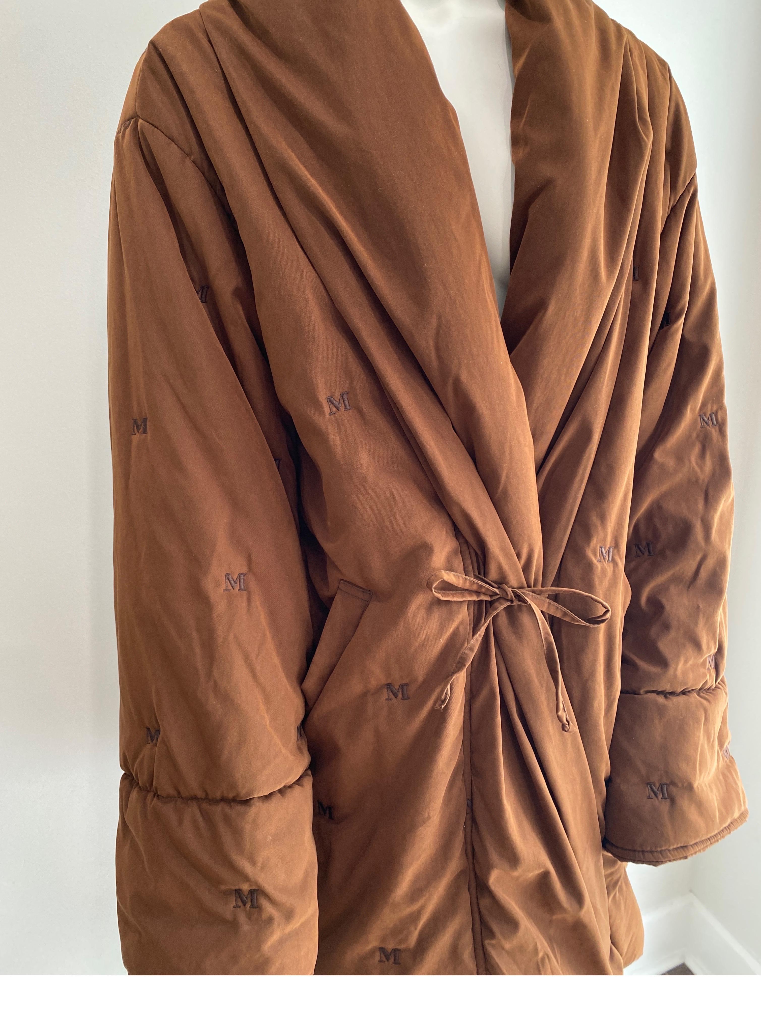MaxMara Vintage 1990's Brown Embroidered Oversized Puffer Coat - US Size 6. This oversized, lined puffer coat has the M embroidered throughout the fabric. It has a slight crossover in the front along with a tie closure, drop sleeve, two front side