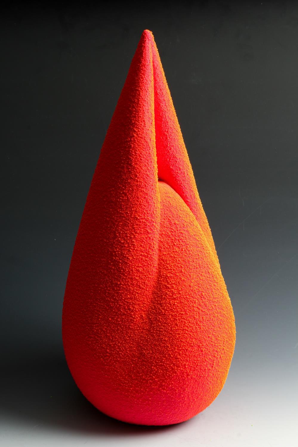 Maxwell Mustardo is a ceramic artist whose highly textured forms are the result of meticulous research into the chemistry of kiln firing. He includes materials such as glass, metals, and plastic in the glazing and post-firing process, resulting in