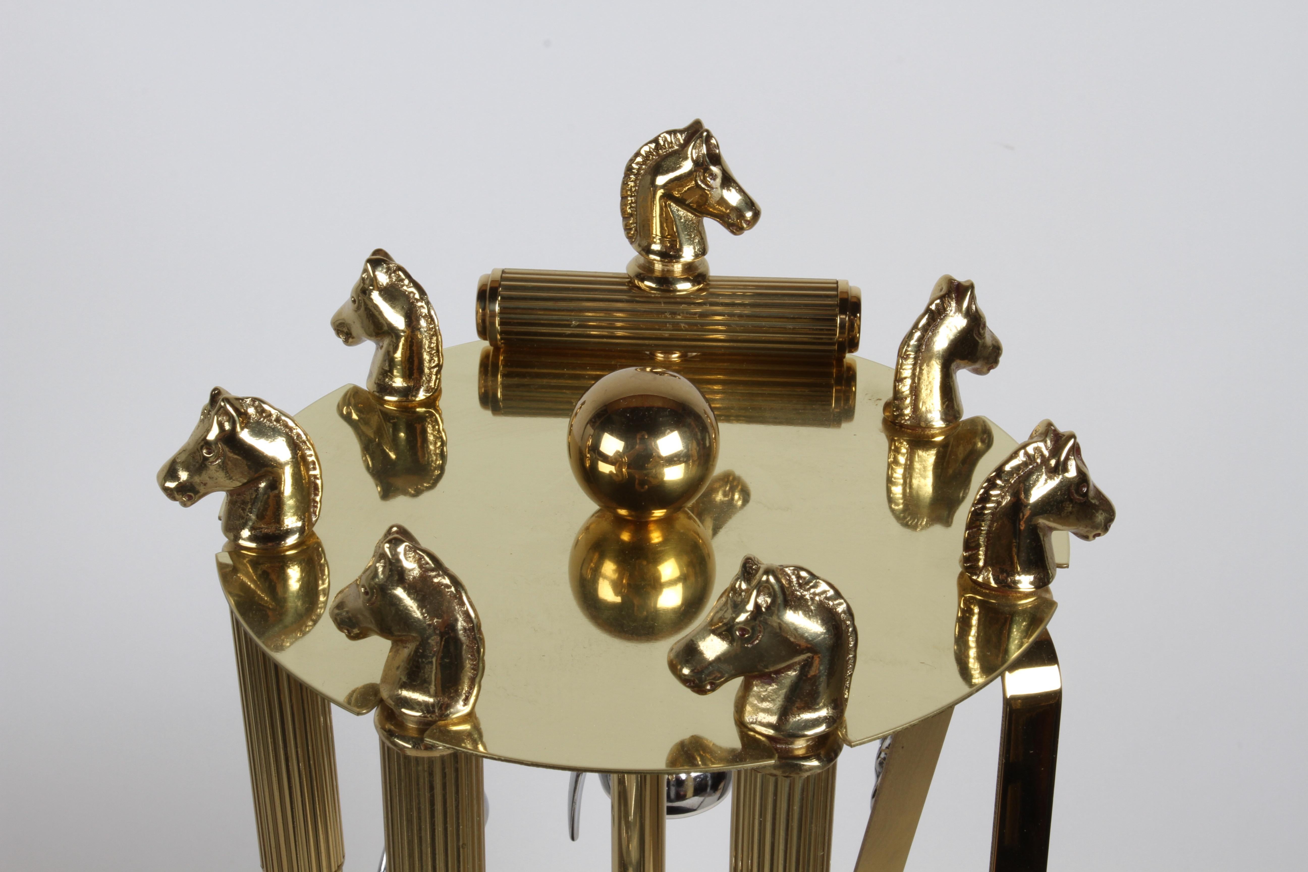 A Handsome, substantial and very well-made 7- piece Mid-Century equestrian theme , Regency brass horse head set of barware or bartender tools on a circular stand by Maxwell Phillip. This set includes hourglass-shaped measuring device, aka as a